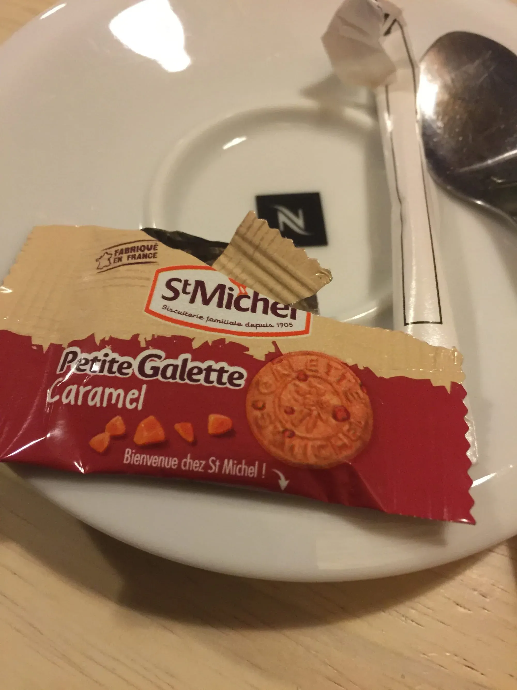 St Michel Petite Galette Caramel cookie on white plate with spoon