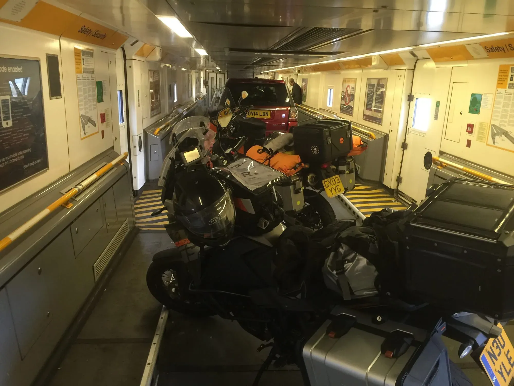 Multiple motorcycles and vehicles loaded inside ferry or transport vessel