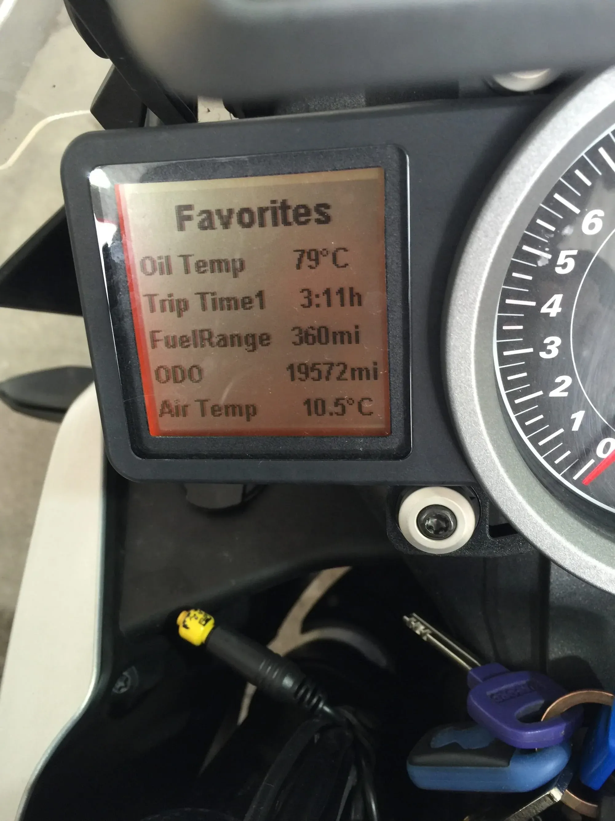KTM motorcycle dashboard orange display showing oil temp 79°C, trip time 3:11h, ODO 19572mi