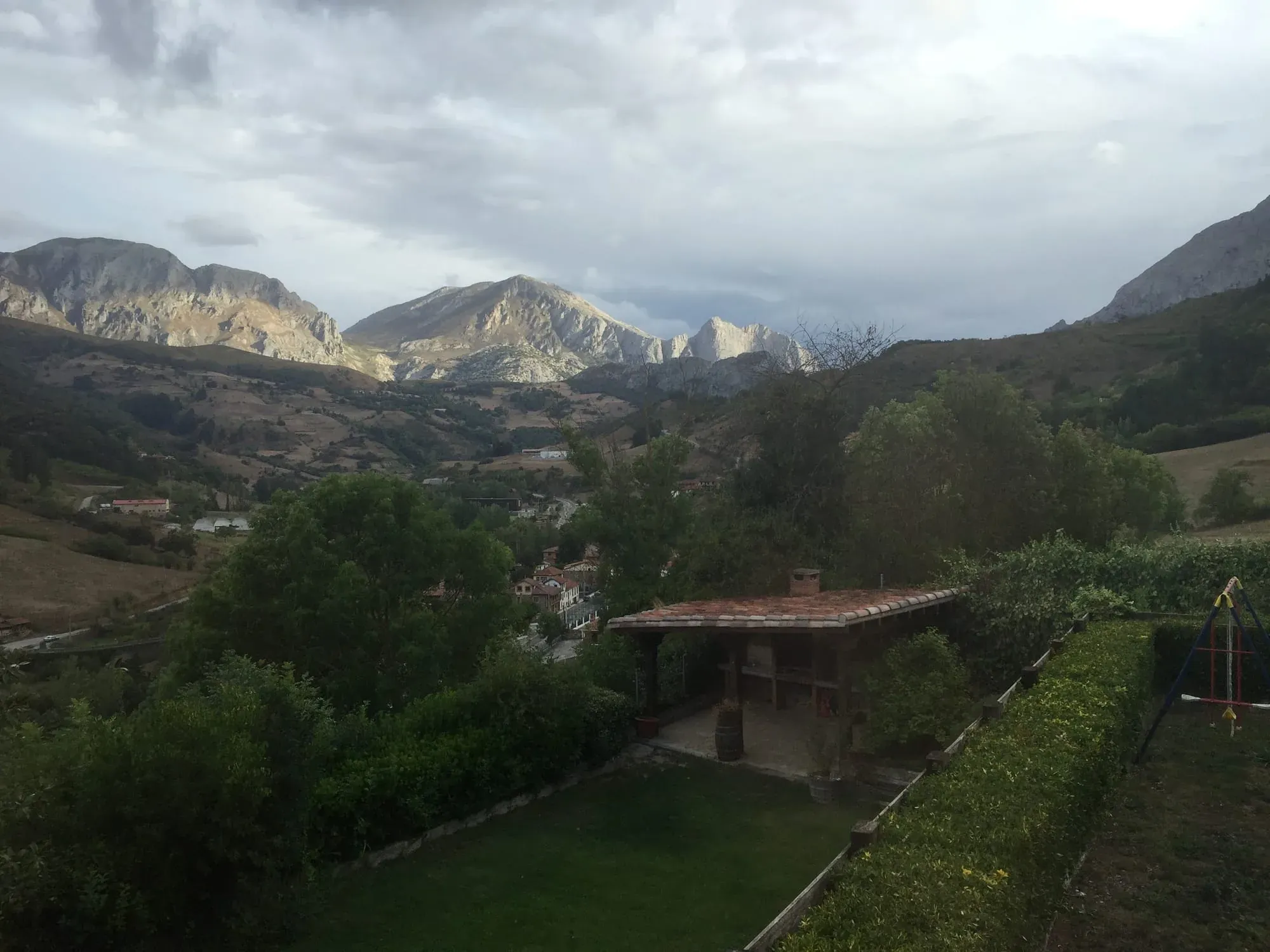 Mountain valley landscape with traditional house and green vegetation