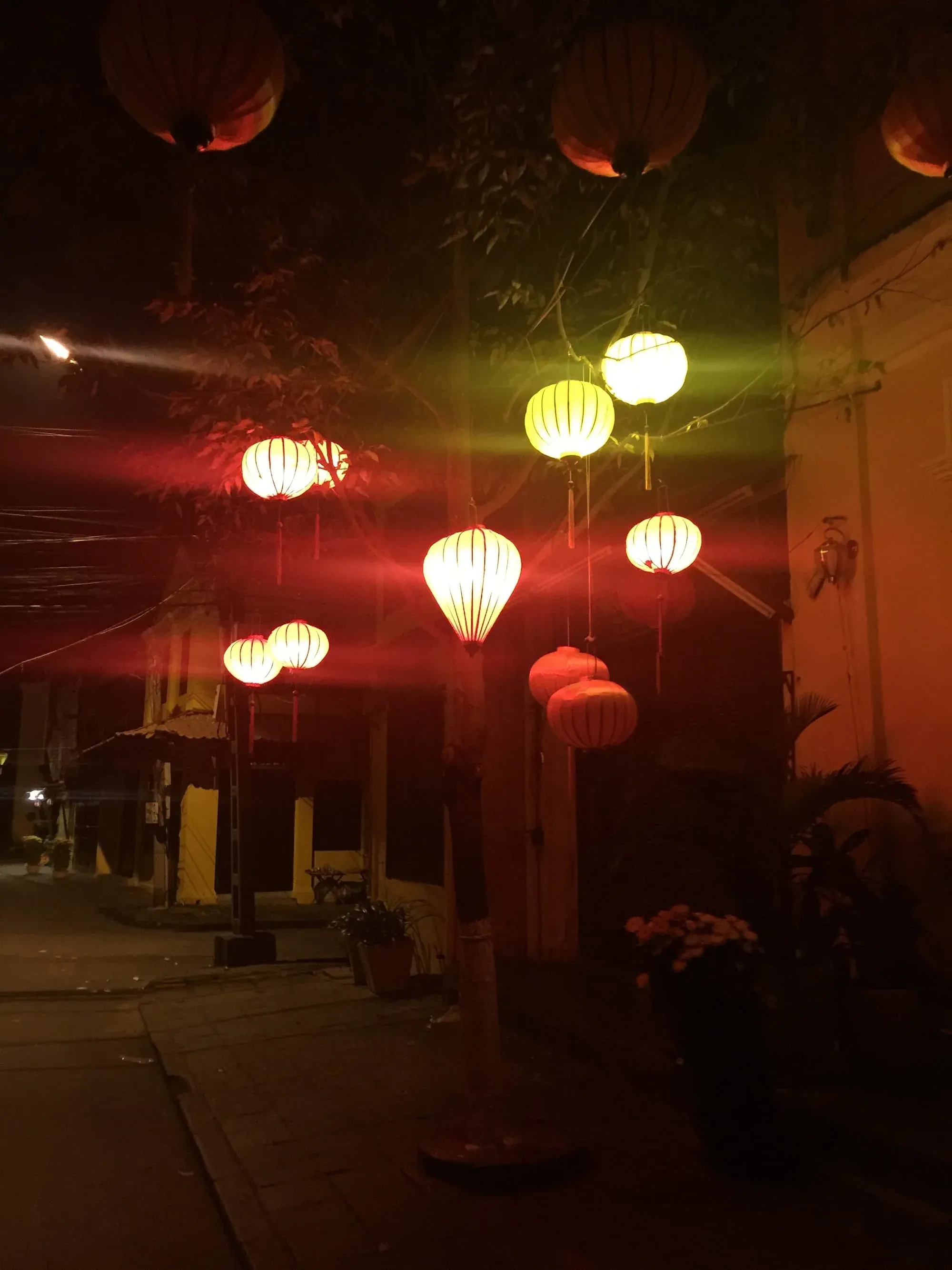 Red and white lanterns hanging at night in traditional Asian street setting