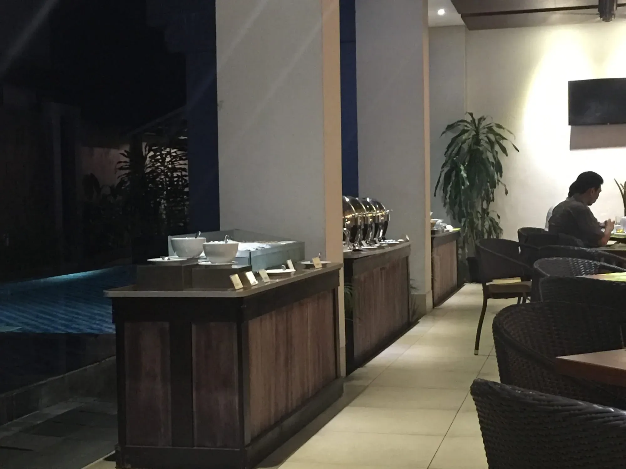 Modern spa or salon interior with reception desk, plants, and seated customer