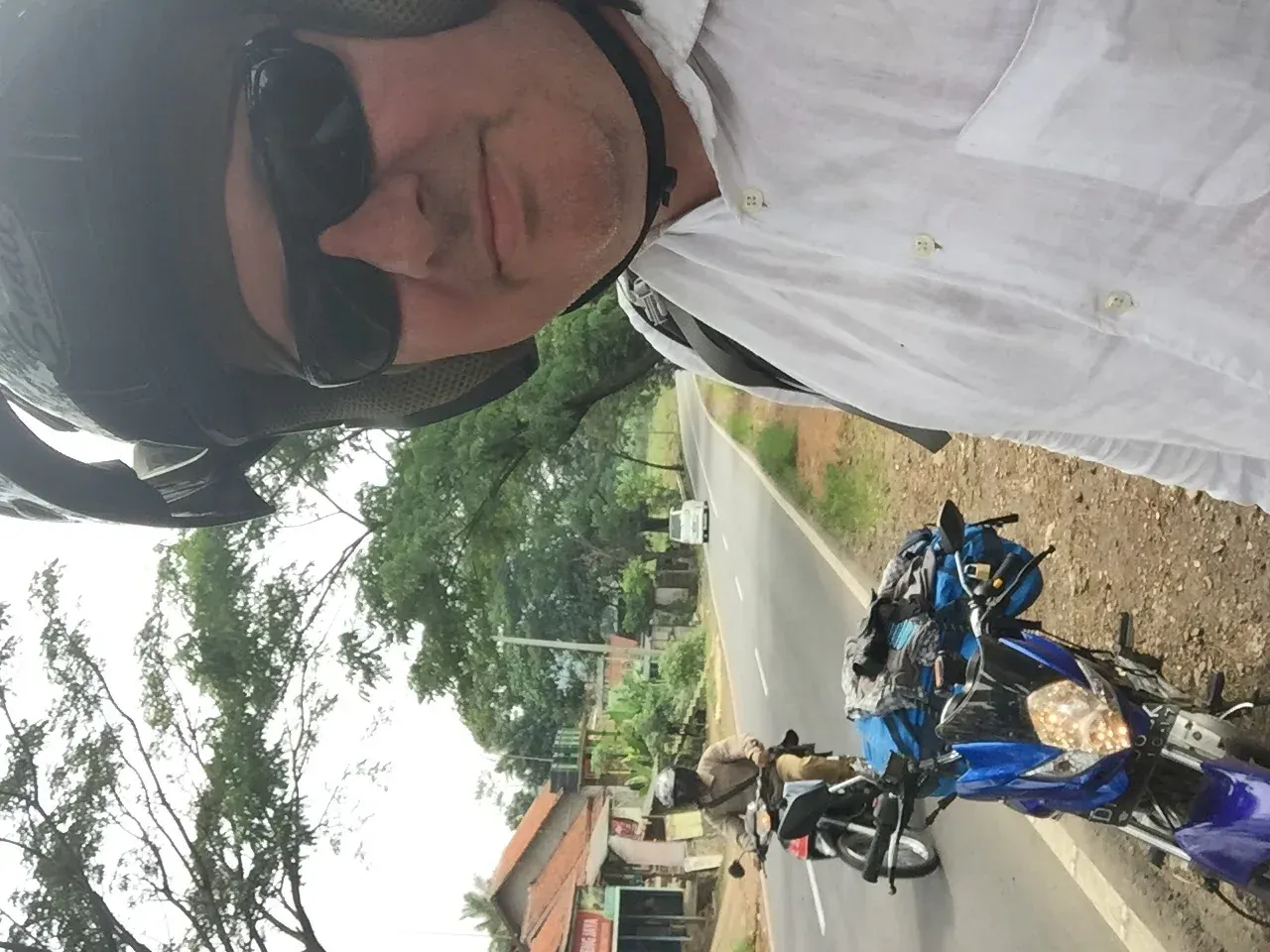 Man in helmet on blue motorcycle, Garut