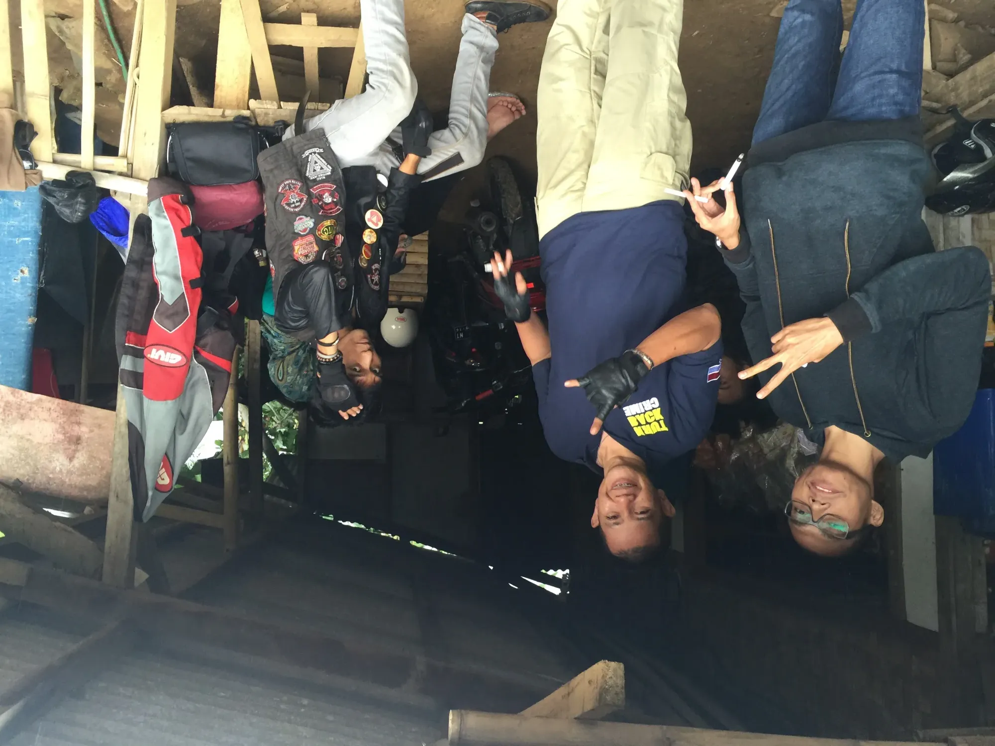 Four people posing in garage workshop, Sukawangi, West Java