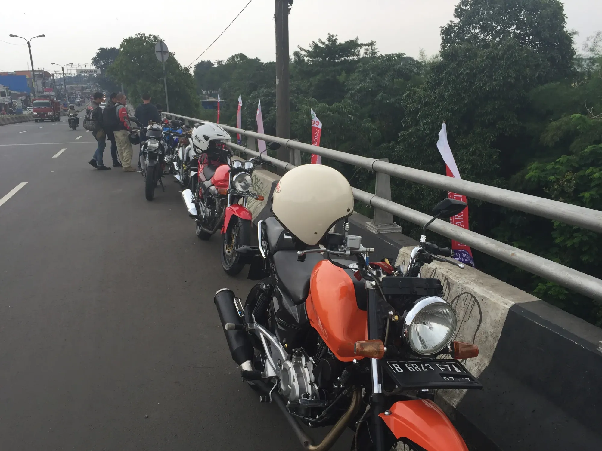 Vintage motorcycles lined up on Cirimekar bridge, Indonesia