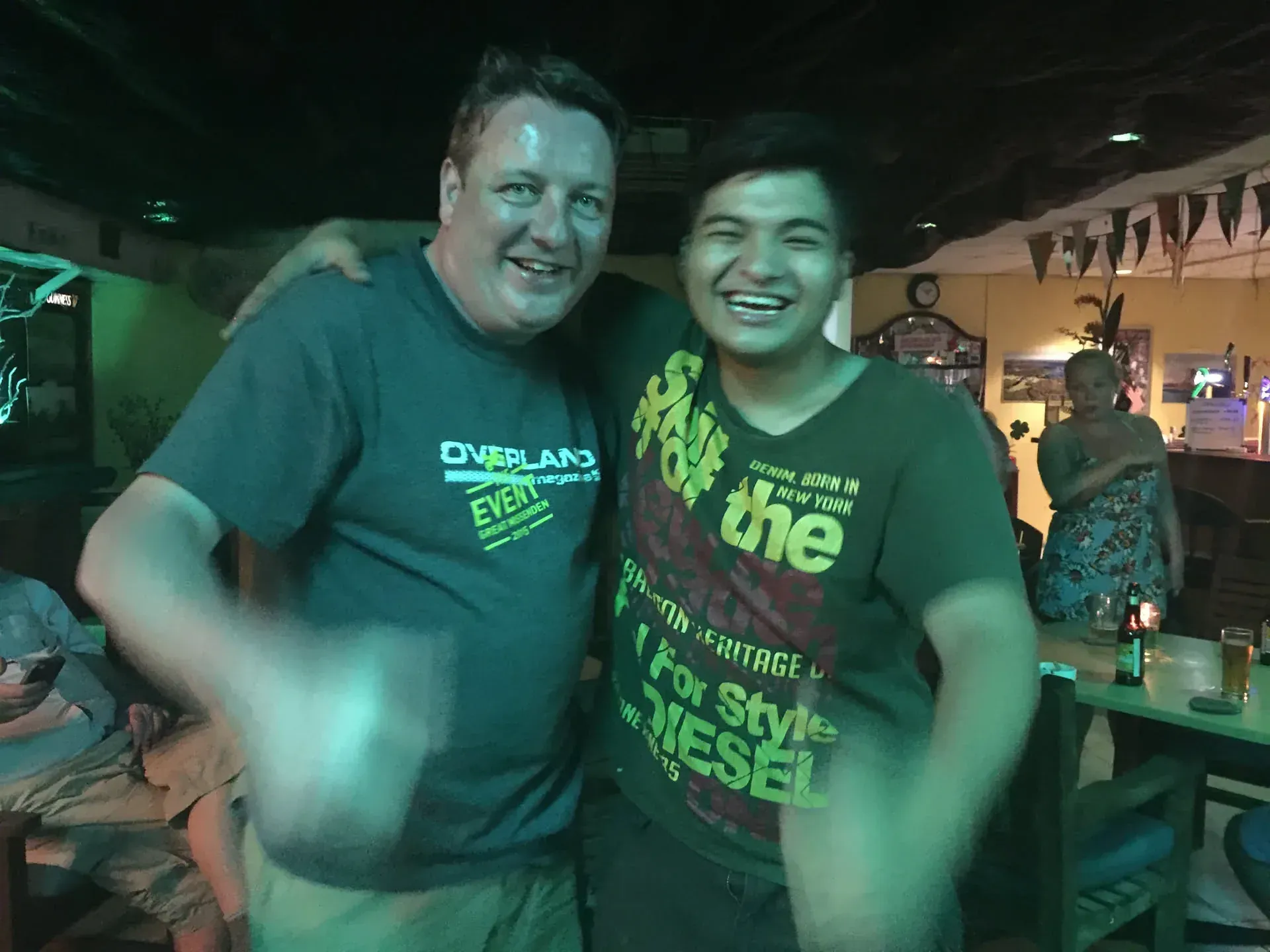 Two men smiling at Cenang Beach bar, Malaysia