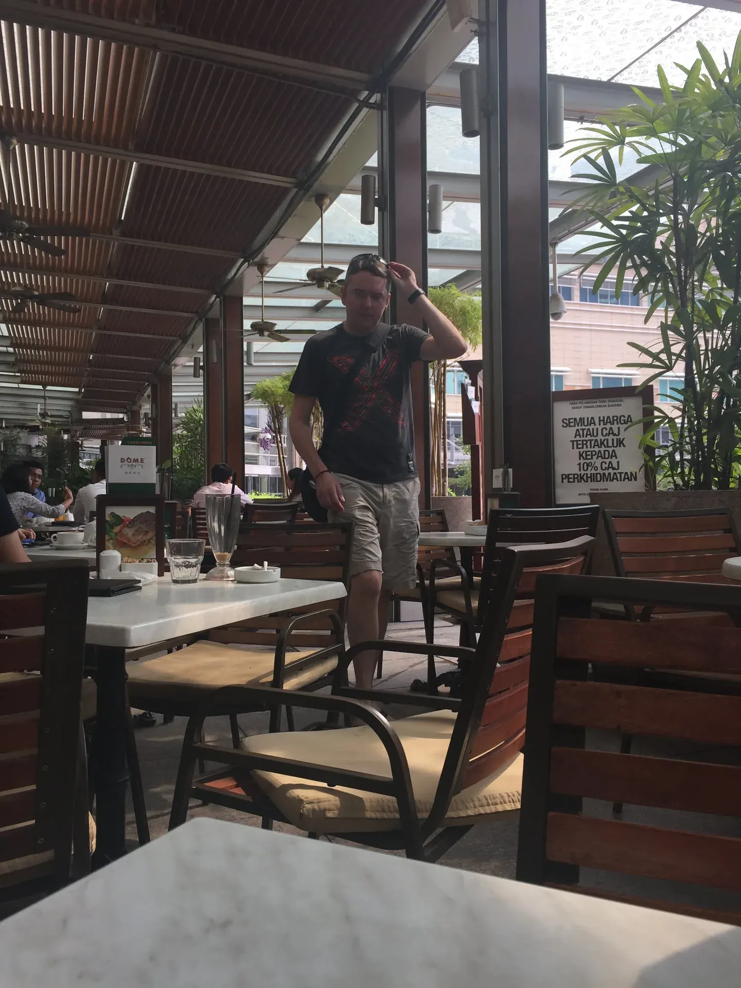 Man standing in café at Bukit Bintang, Kuala Lumpur