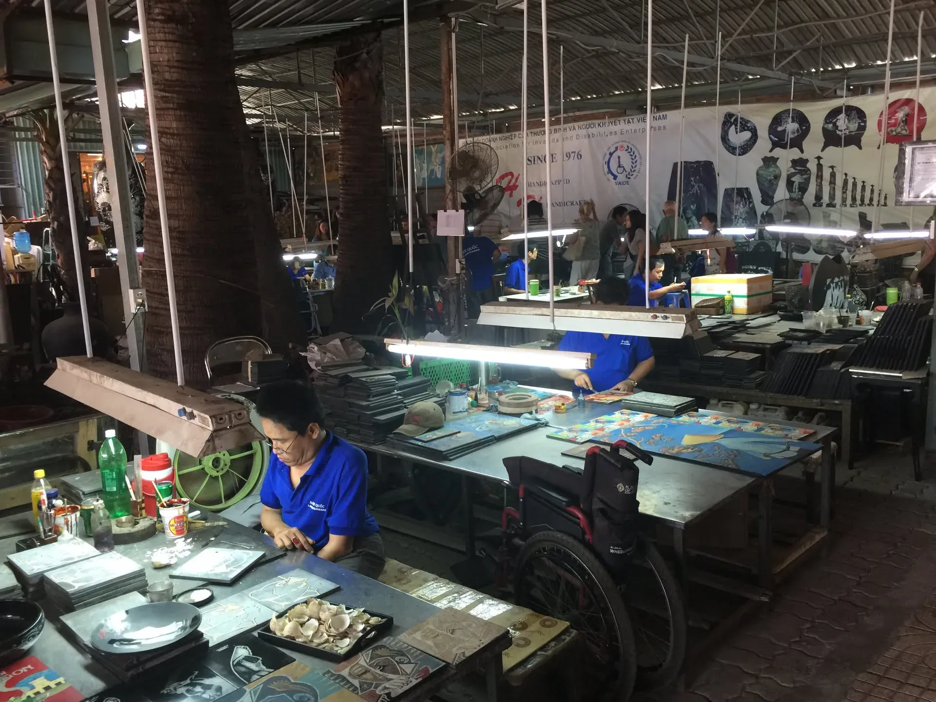 Workers painting ceramics at workshop in Xuan, Vietnam