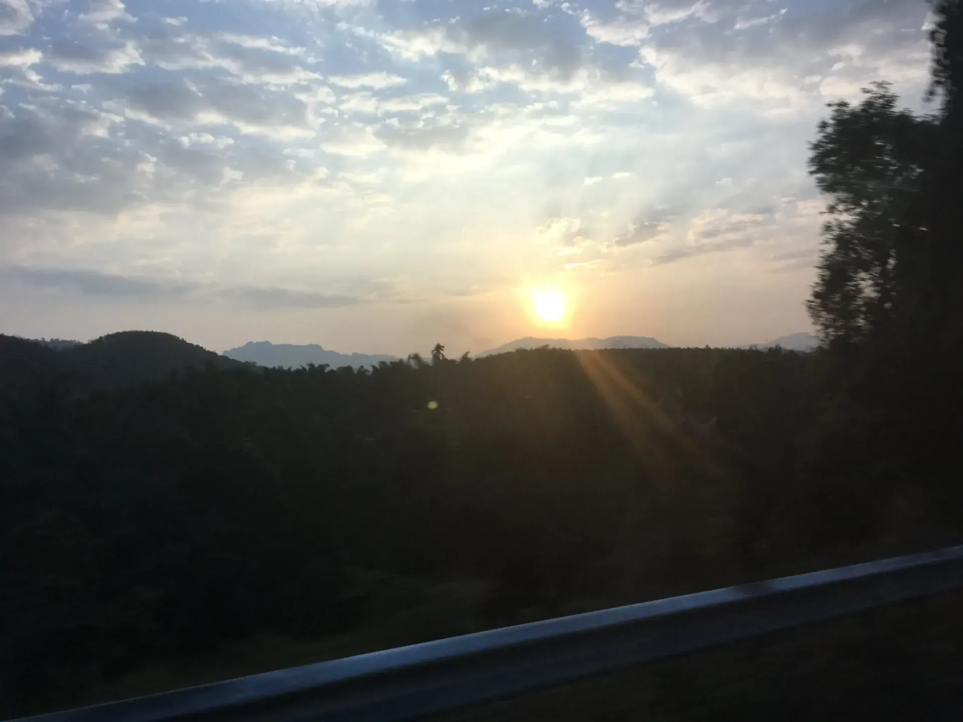Sunset over forested mountains, Surat Thani Province