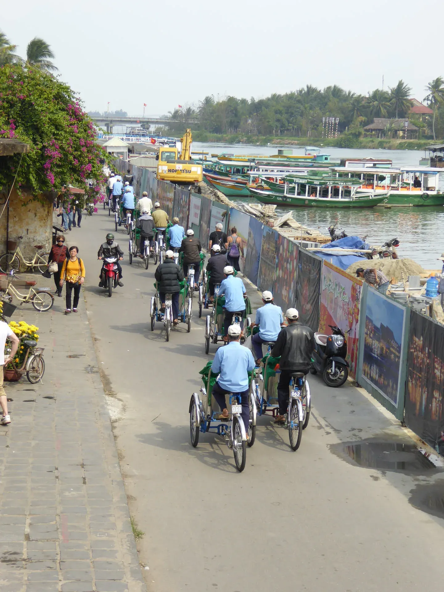 Cyclists and pedestrians on riverside path, Hoi An