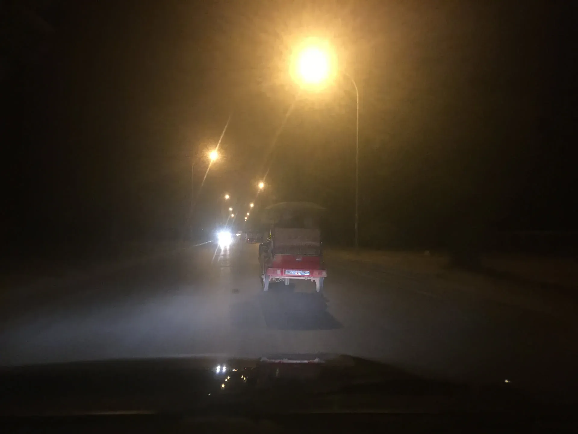 Truck driving through fog at night, Siem Reap