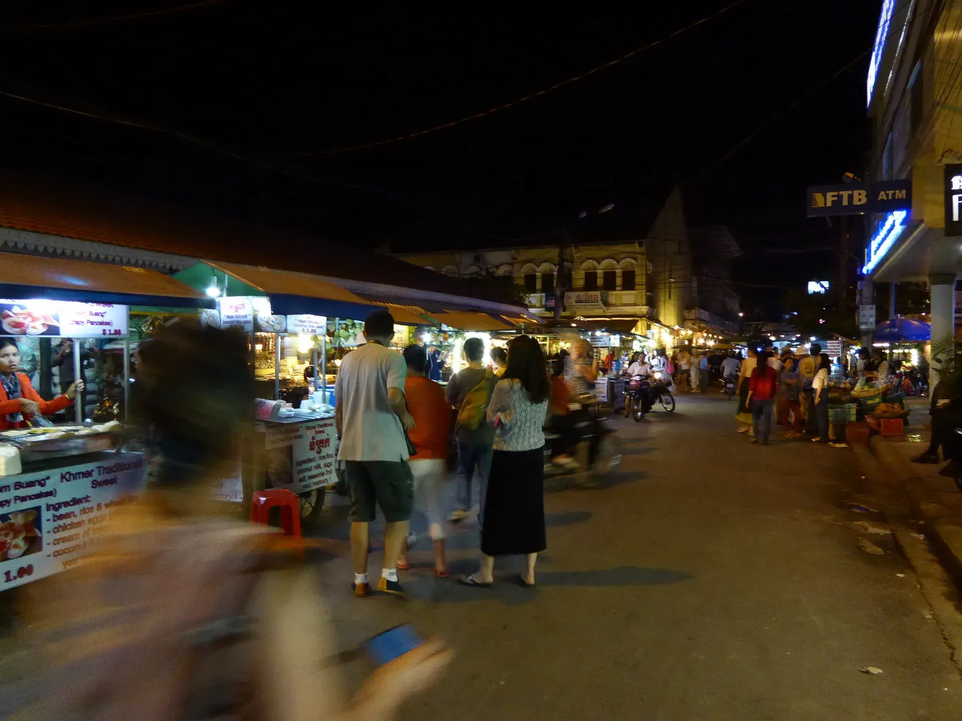 Night market street with food stalls and crowds