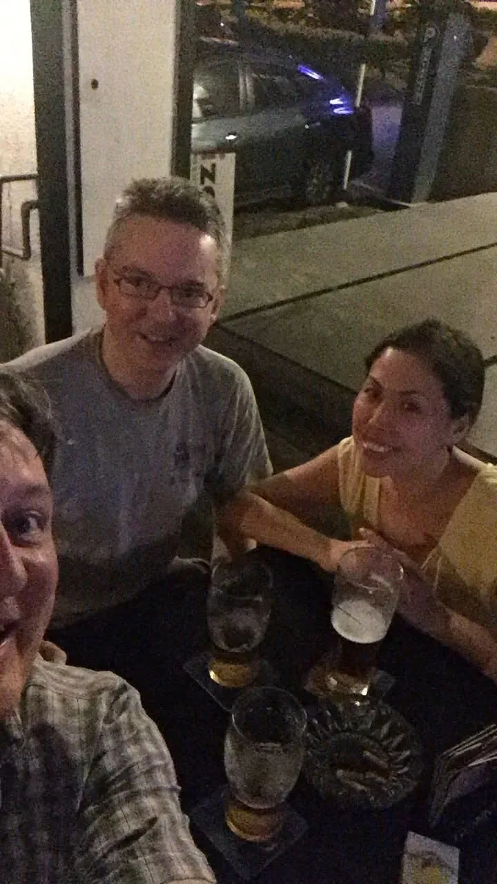 Friends enjoying drinks at a bar indoors
