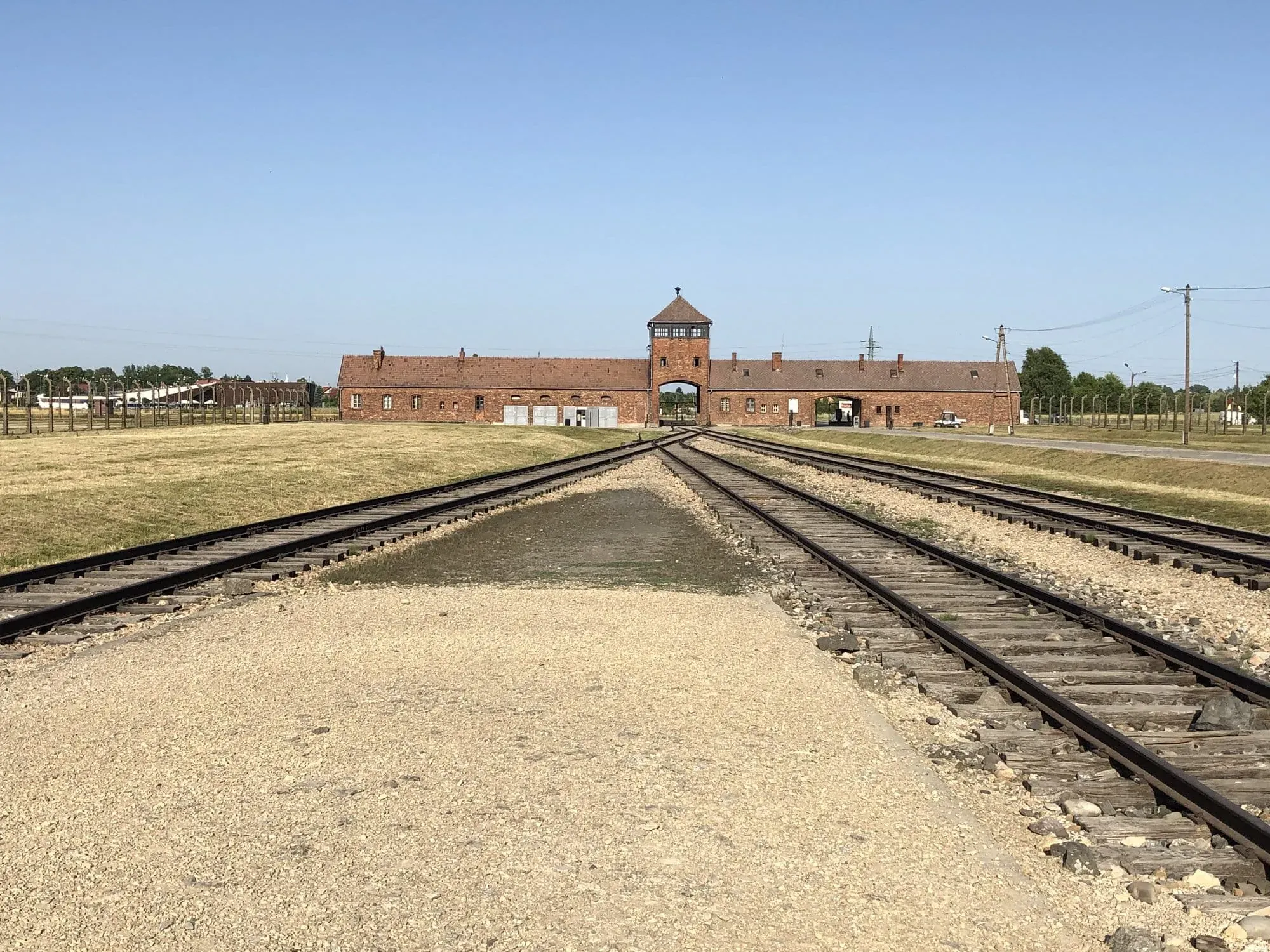 Railroad tracks leading to brick gatehouse at Auschwitz concentration camp