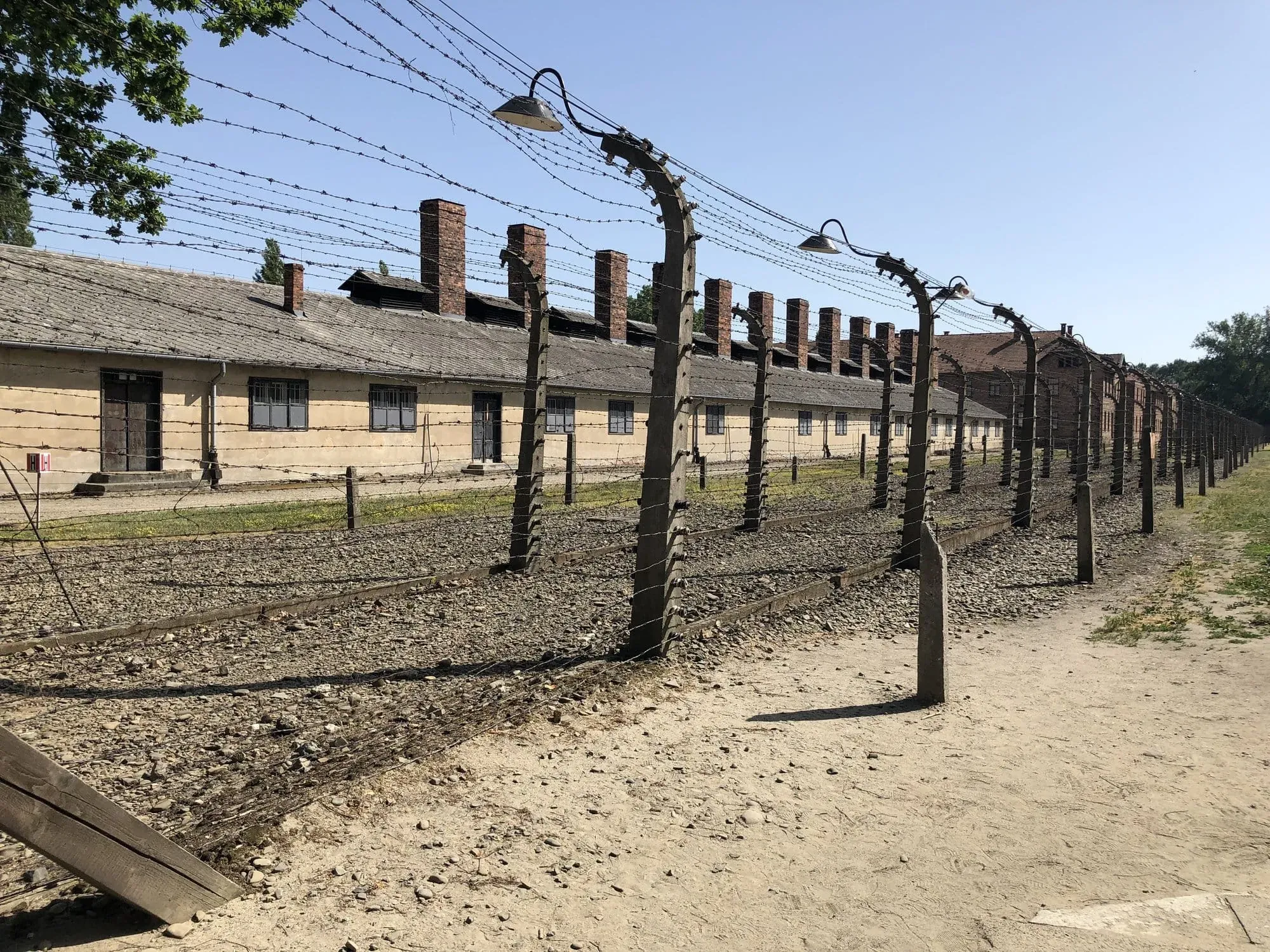 Auschwitz concentration camp barracks with electrified barbed wire fencing