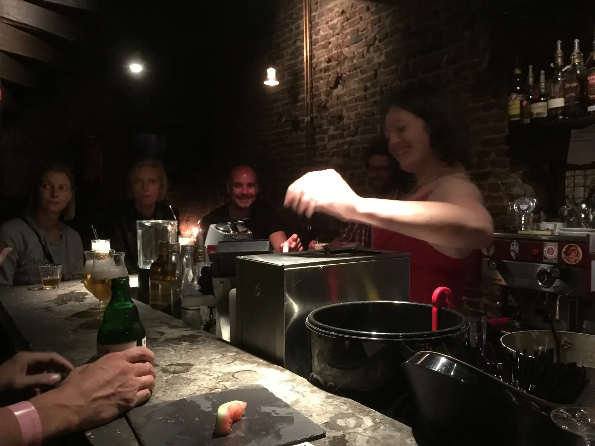 Bartender pouring drink at Ghent bar counter