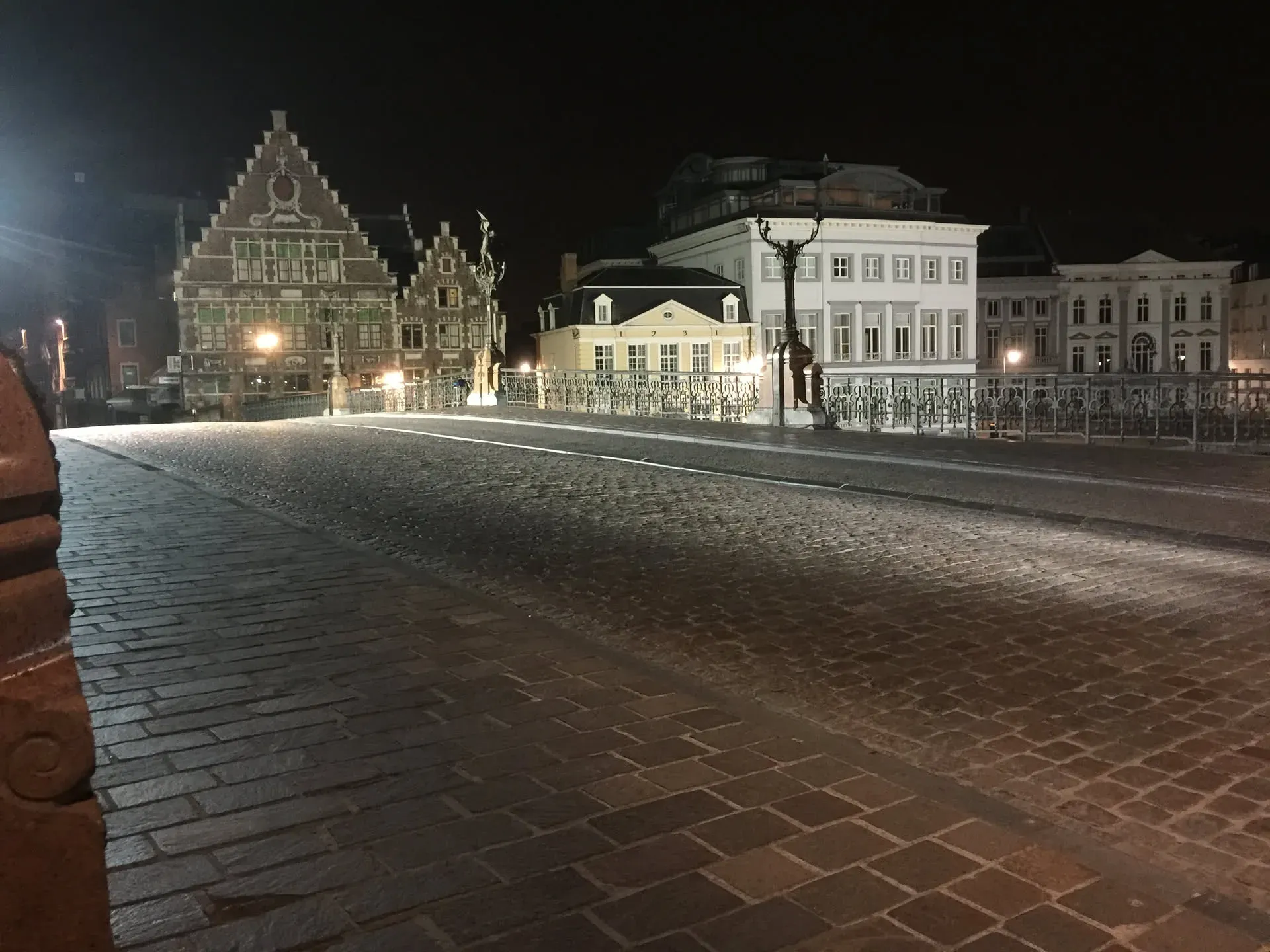 Night view of historic bridge and buildings in Ghent