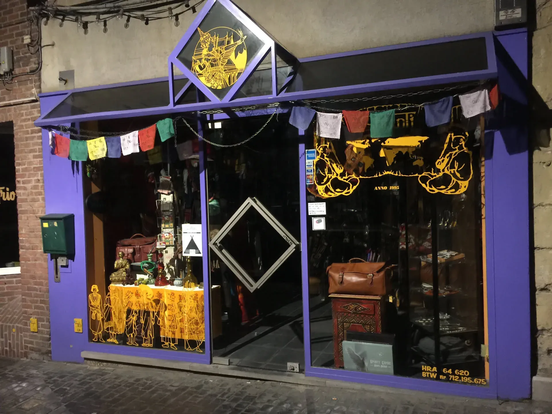 Purple storefront with Buddha statue in Ghent