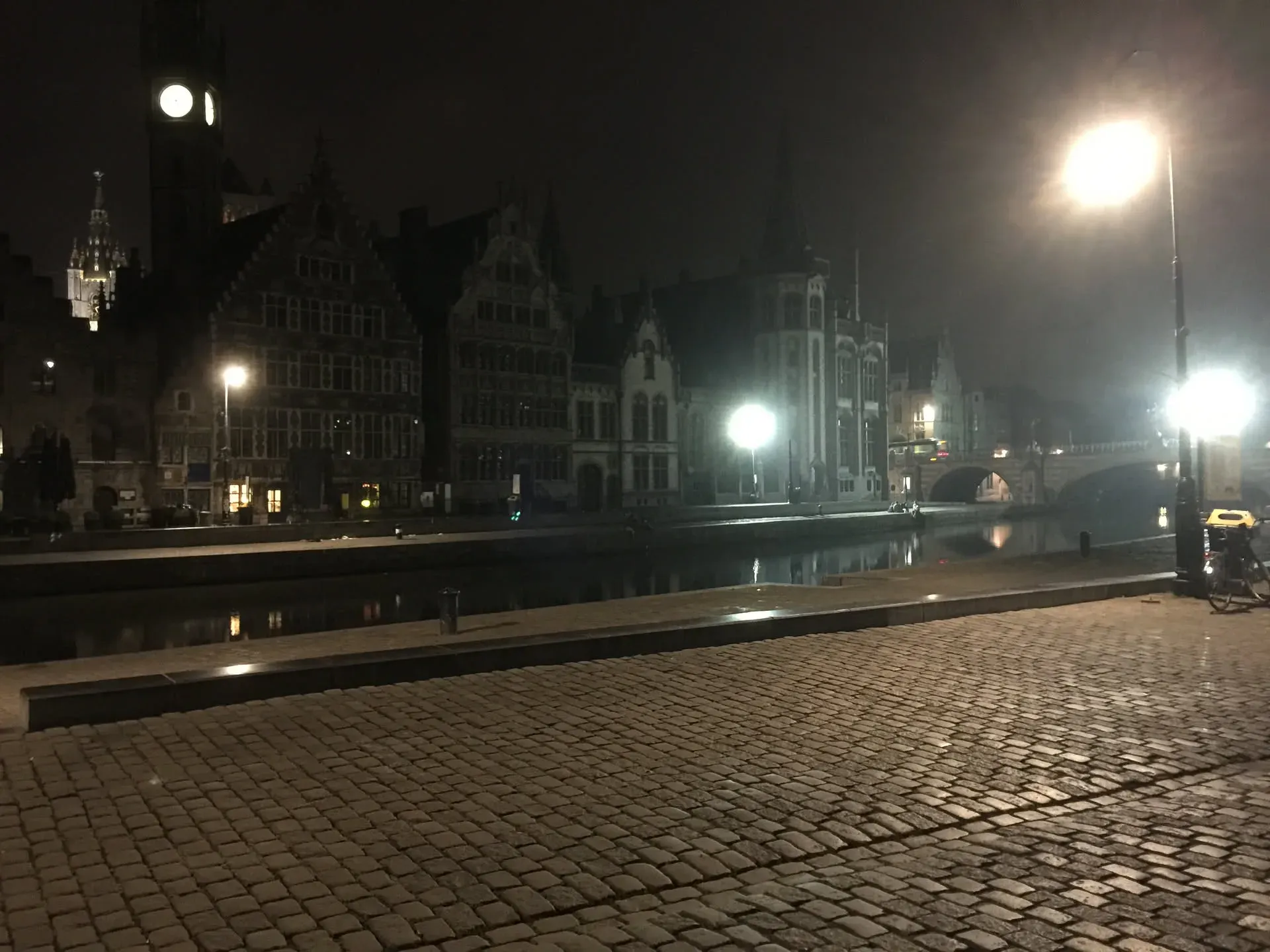 Night canal view with historic buildings in Ghent