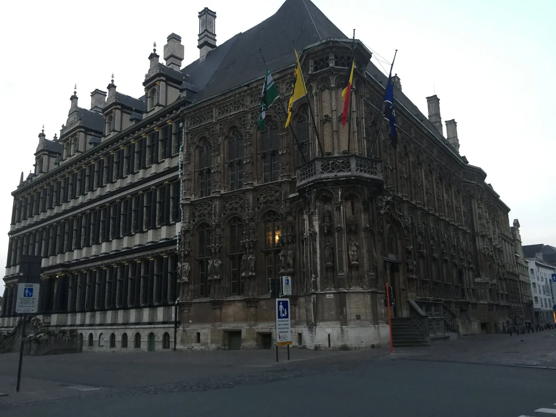 Ornate Gothic building with flags in Ghent