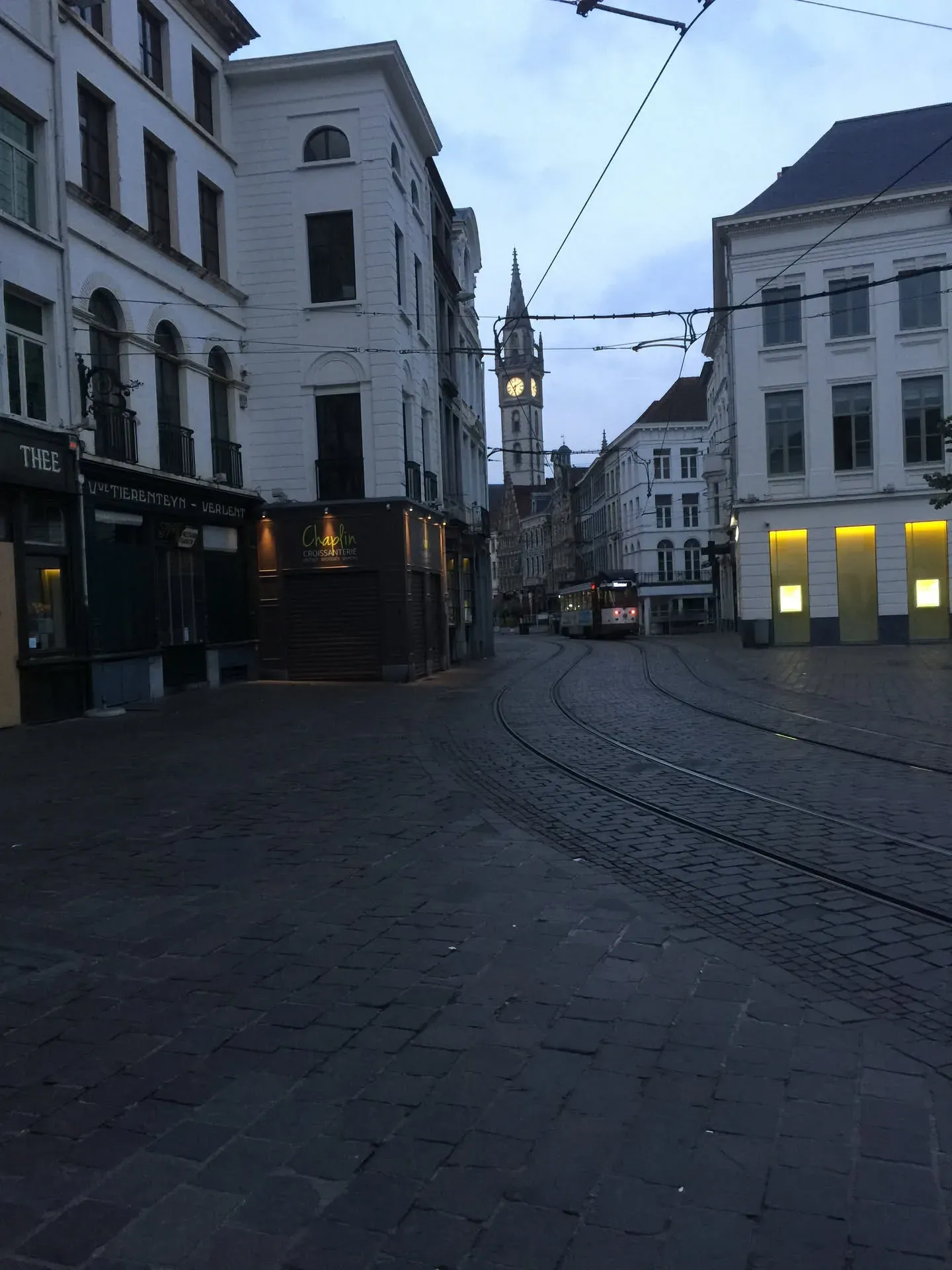 Tram tracks through Ghent's historic city center at dusk