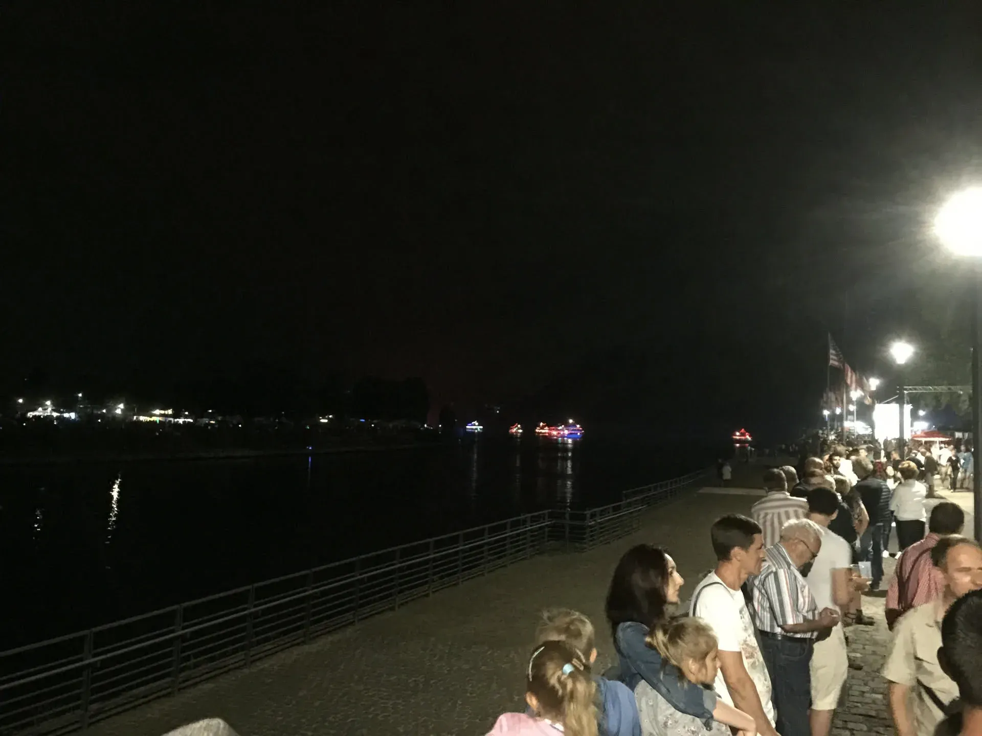 Crowds gathering on Altstadt waterfront at night