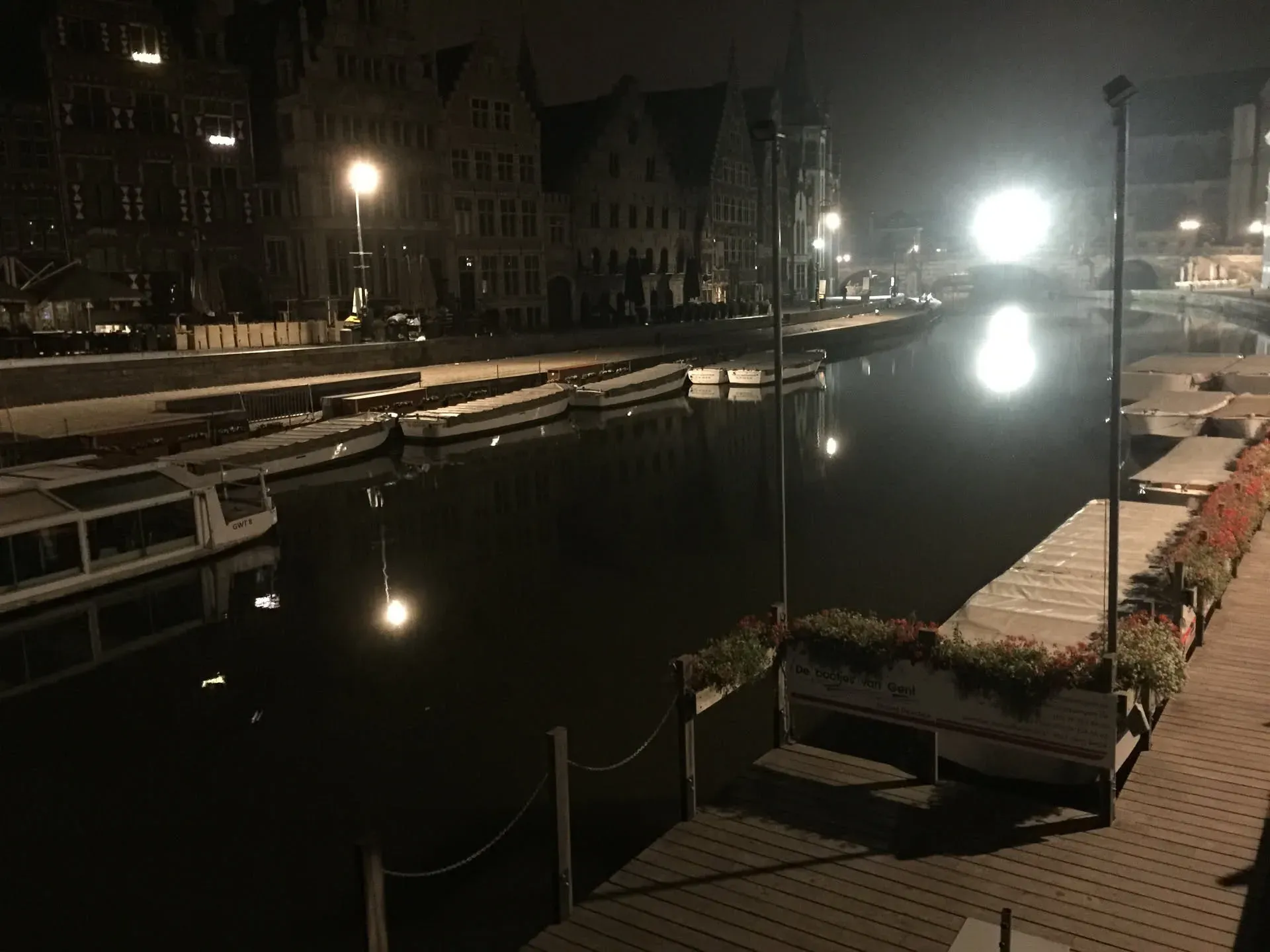 Moored boats at night in Ghent harbor