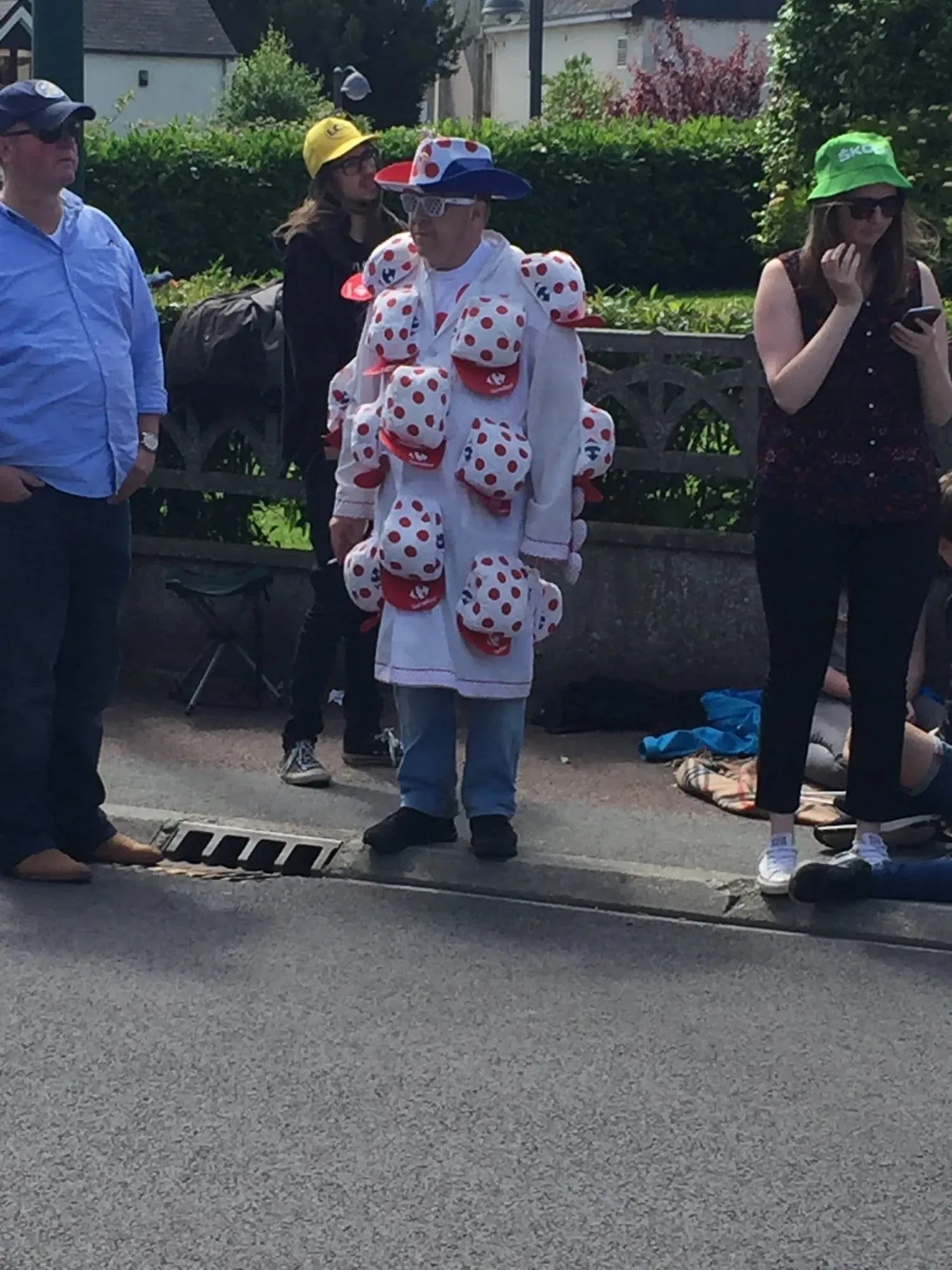 Person in polka dot costume surrounded by spectators outdoors
