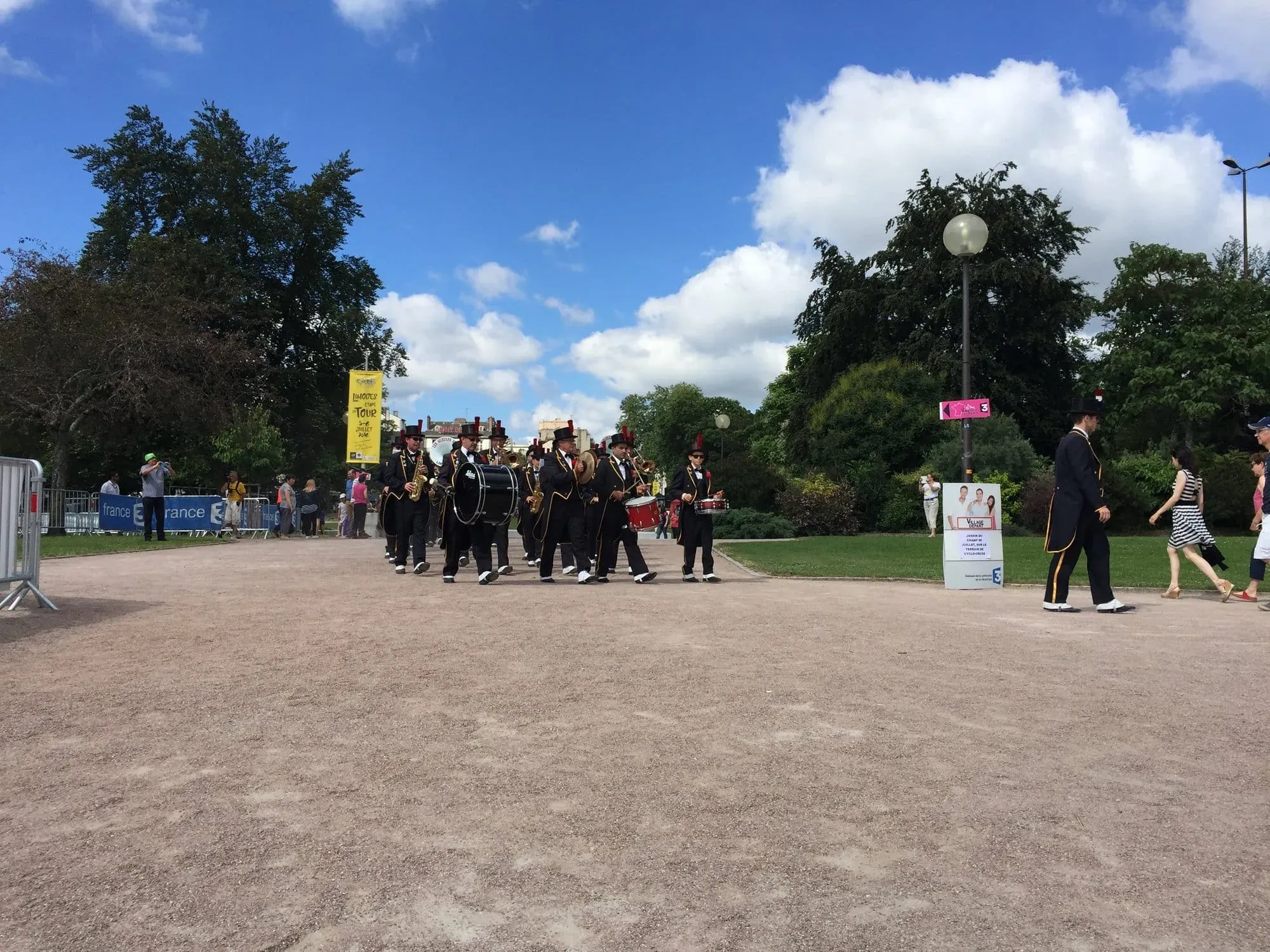 Marching band in formal uniforms parading through park