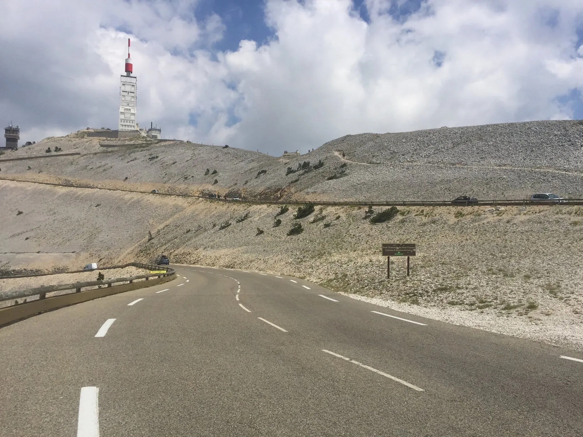 Mountain road with tower and communication antenna on hilltop