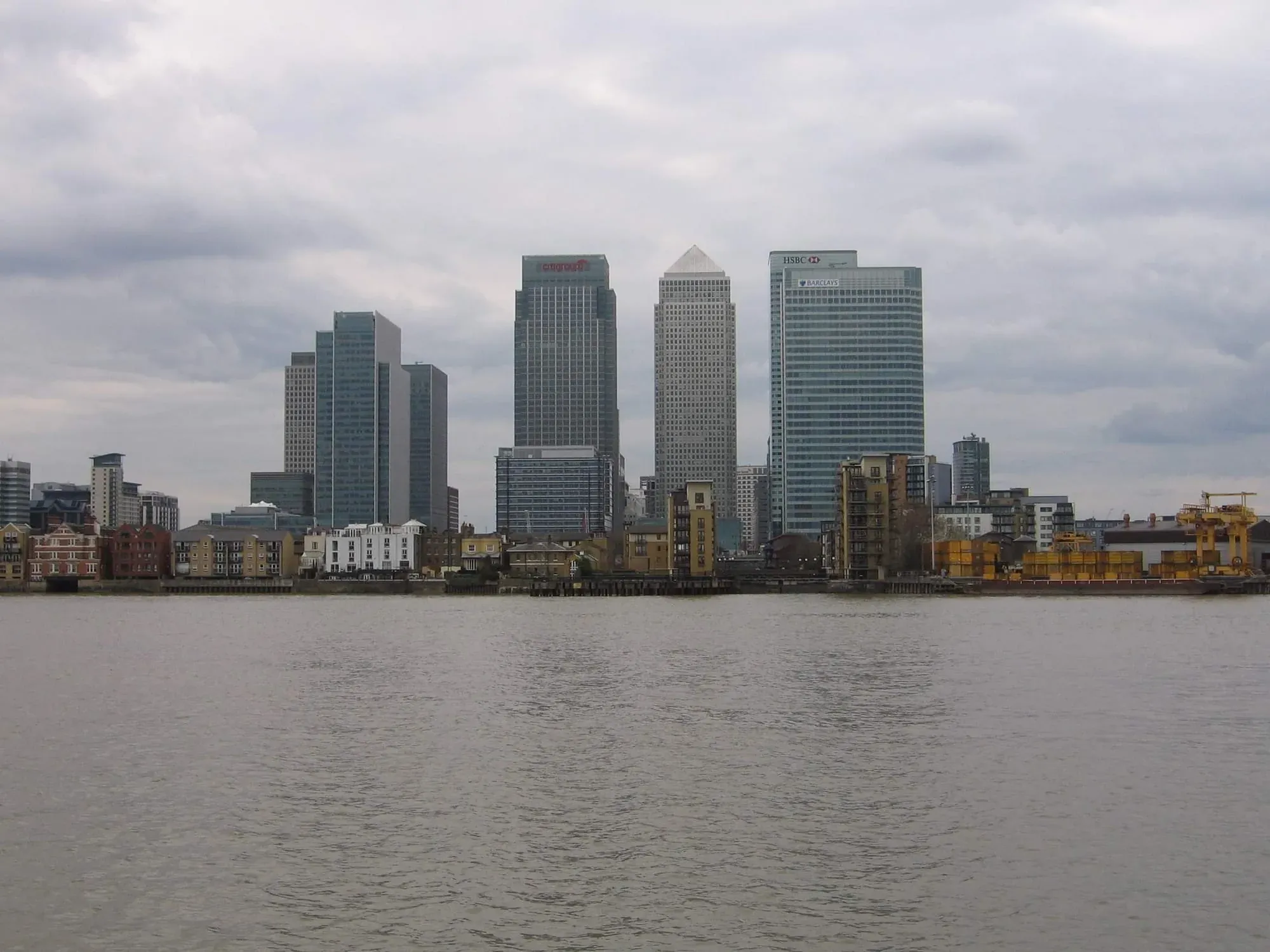 Canary Wharf financial district skyline reflected in Thames river waters