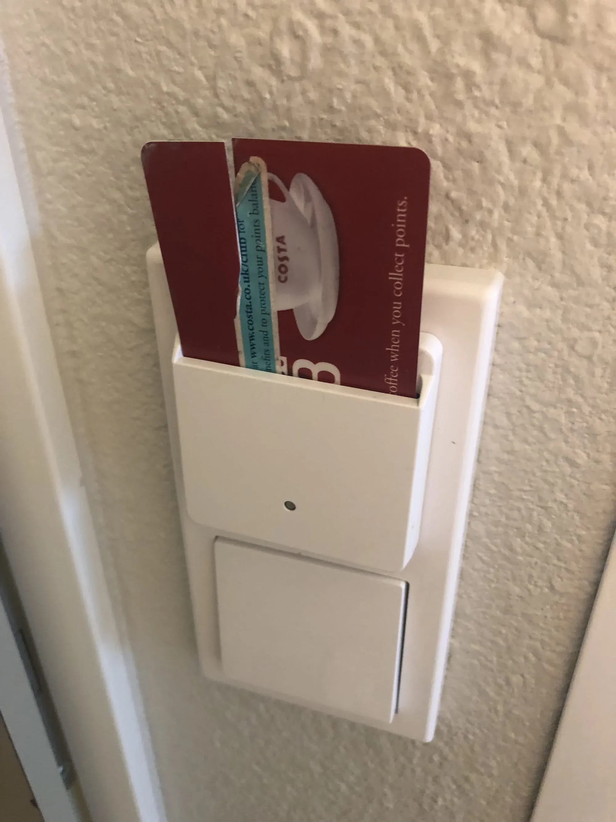 Costa Coffee loyalty card in white wall-mounted card holder