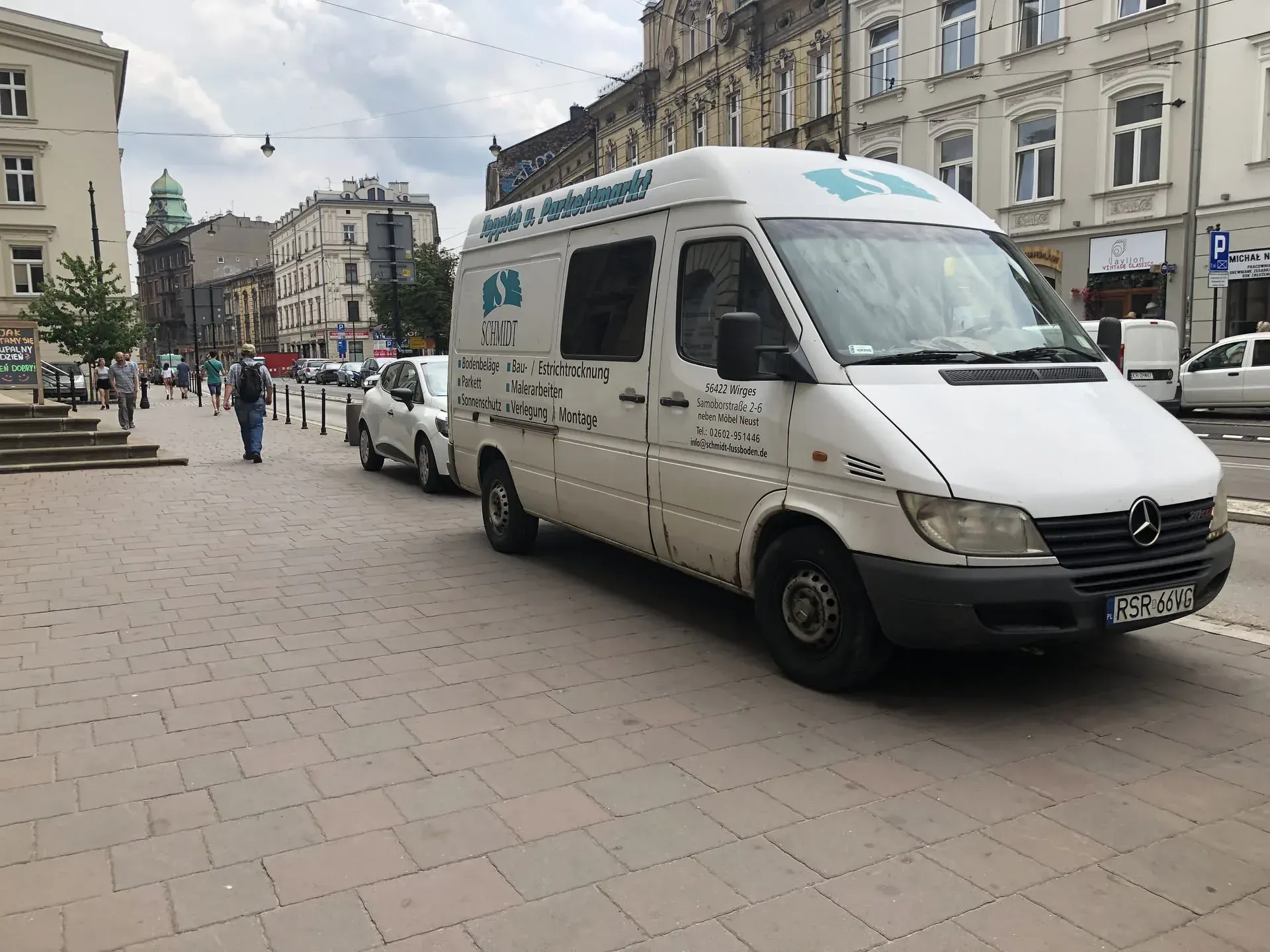 White service van parked in Stare Miasto square
