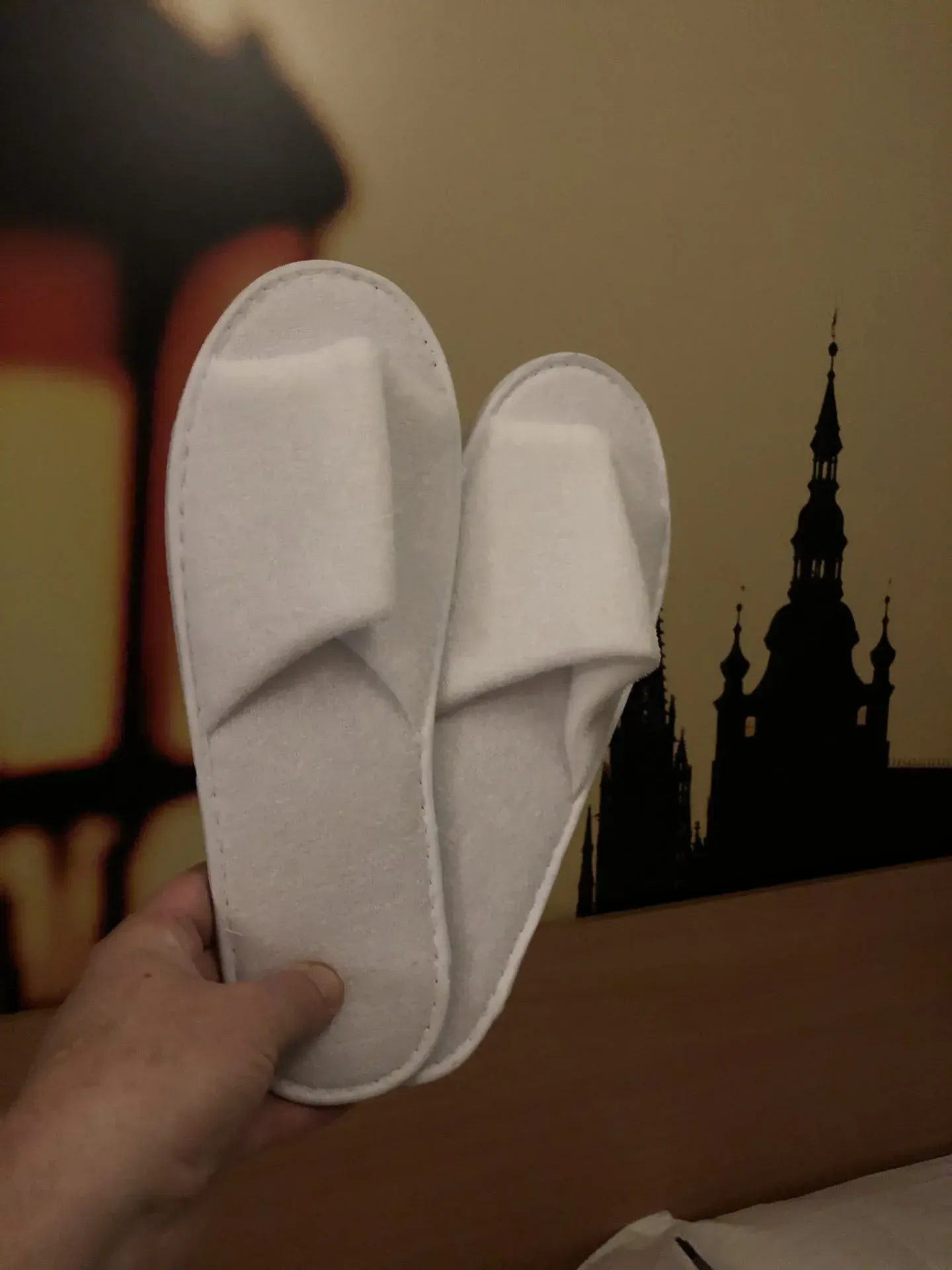 White slippers held up in Obvod, Prague