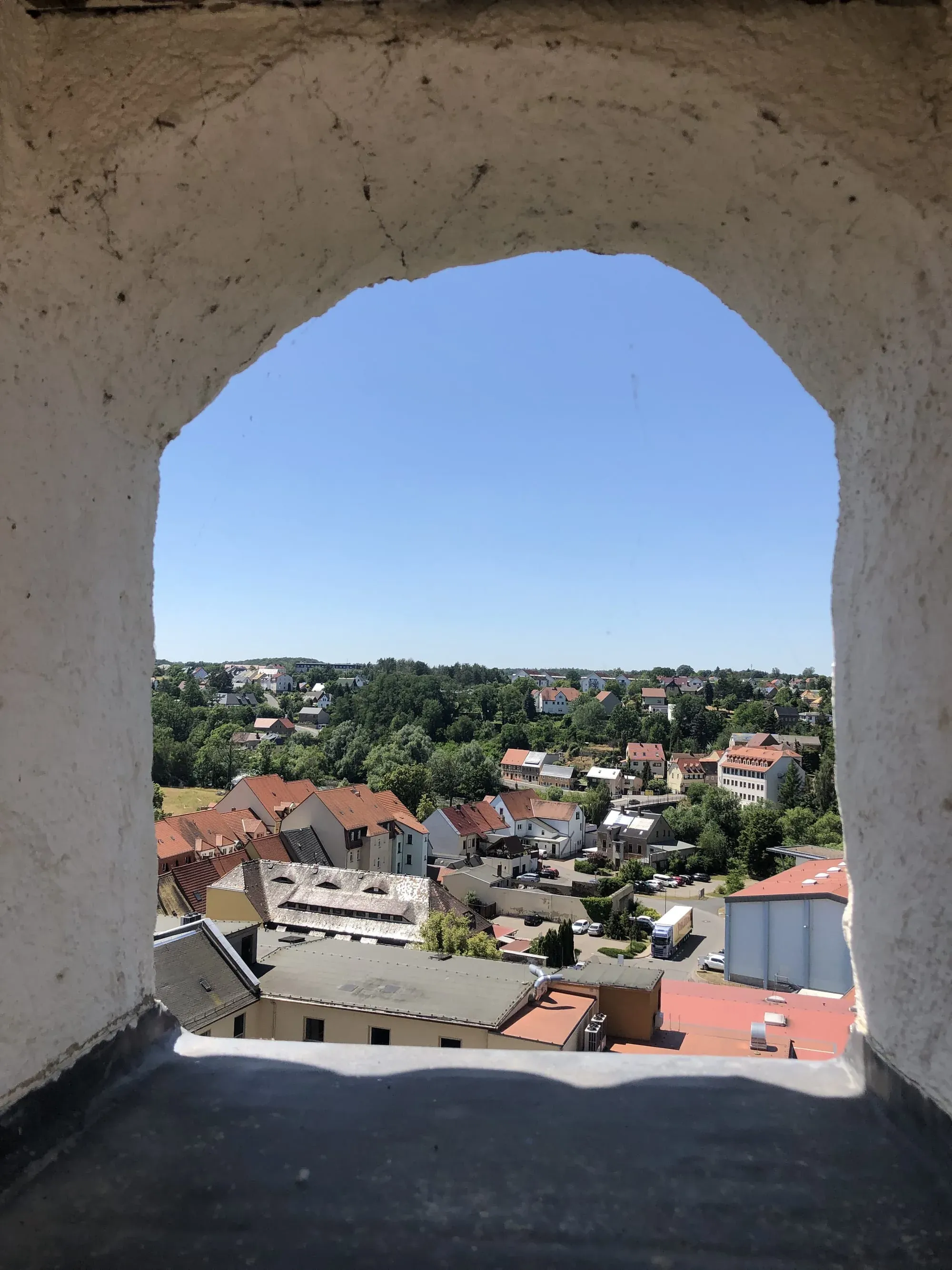Town landscape view through concrete archway window opening