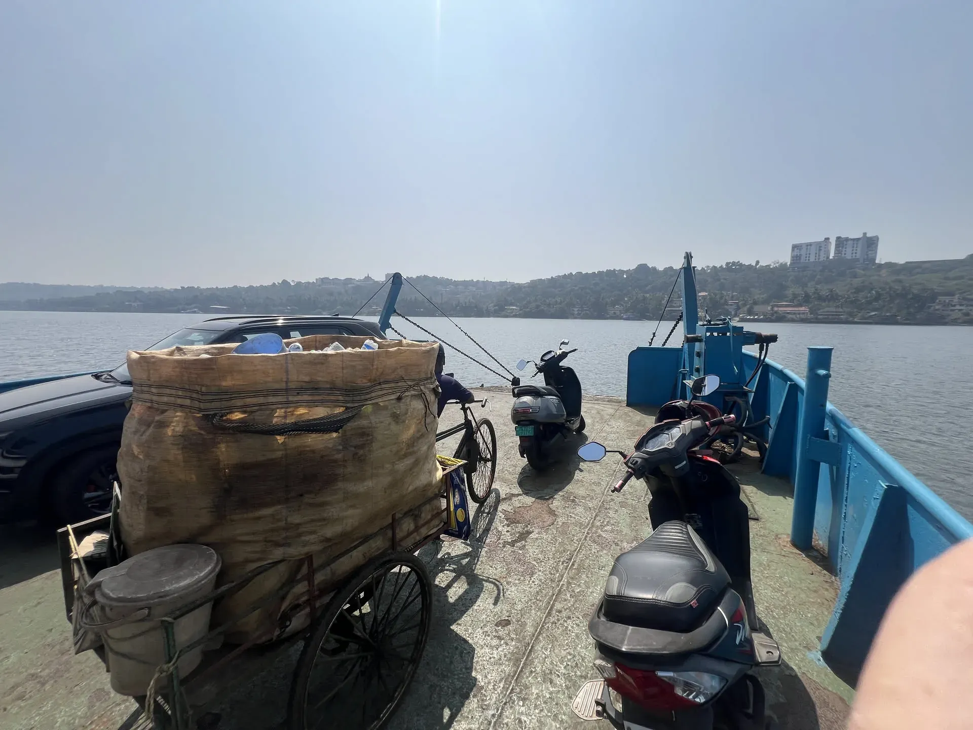Ferry dock at Ribandar with scooters and boats