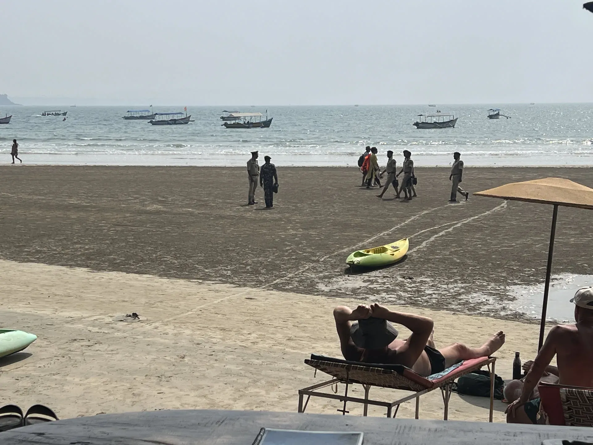 Tourists relaxing on beach at Devbag, Goa