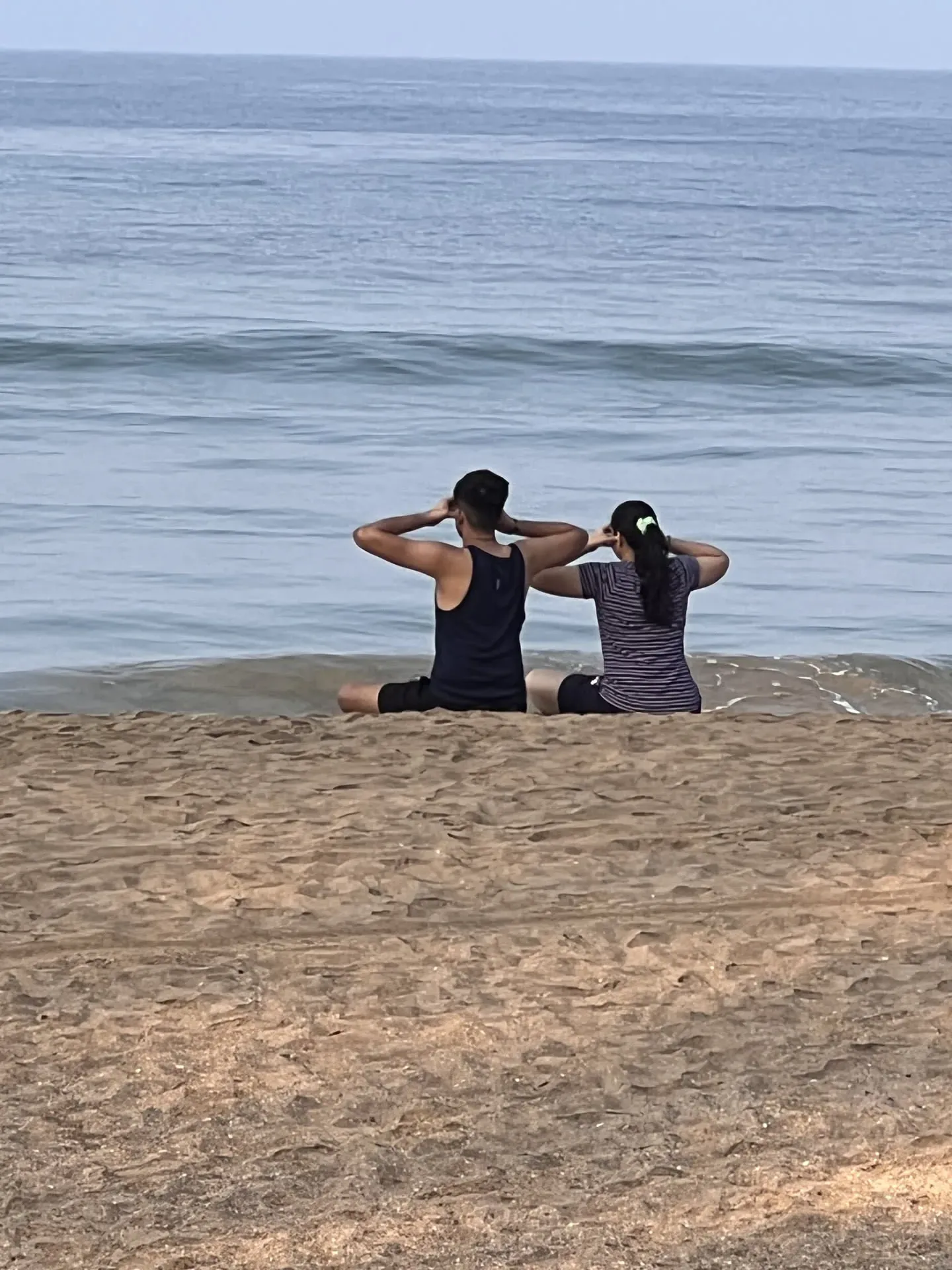 Two people sitting on beach at Agonda