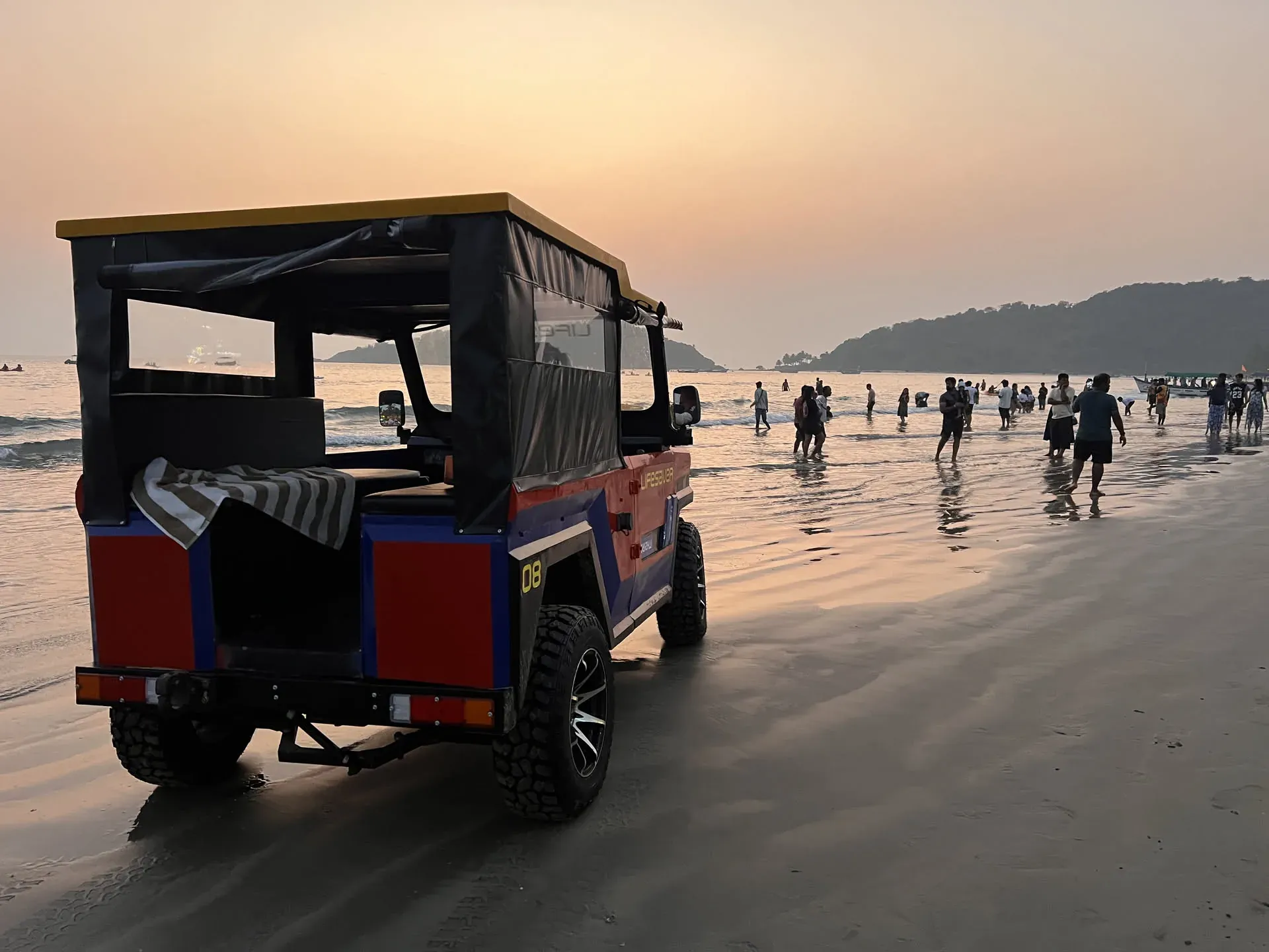 Auto-rickshaw parked on Devabag beach at sunset