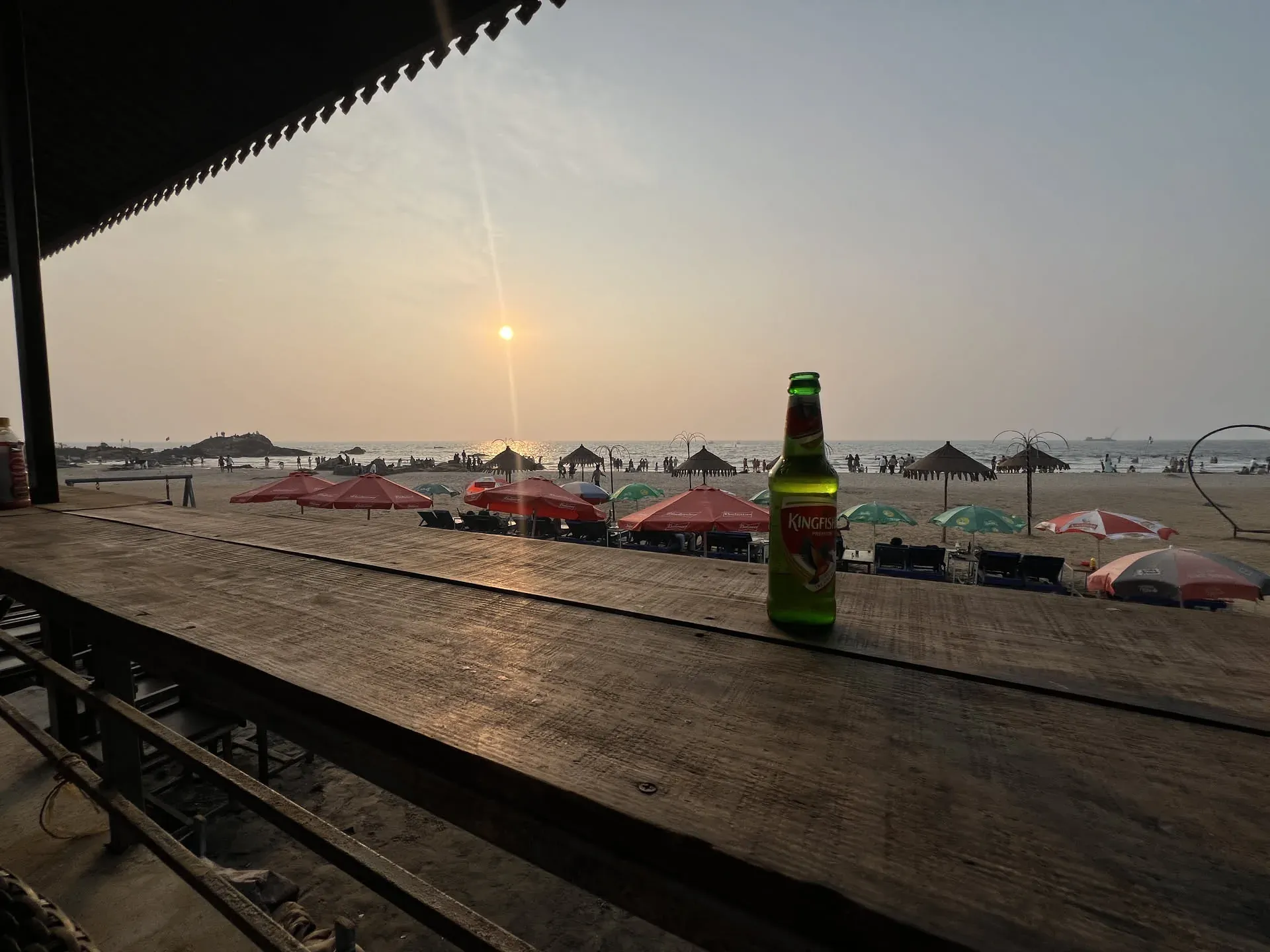 Kingfisher beer bottle at Anjuna beach at sunset