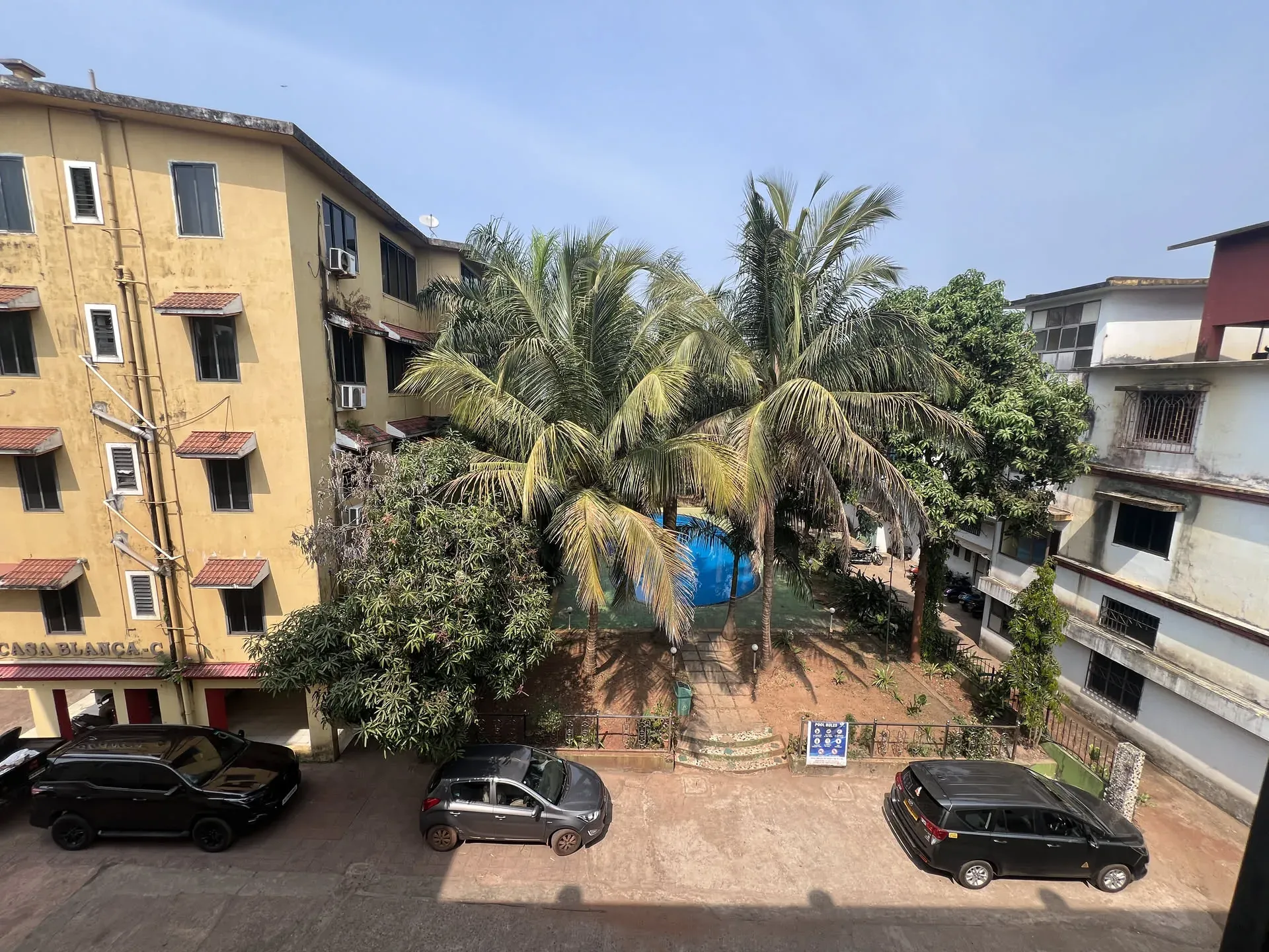 Residential courtyard with palm trees, Anjuna