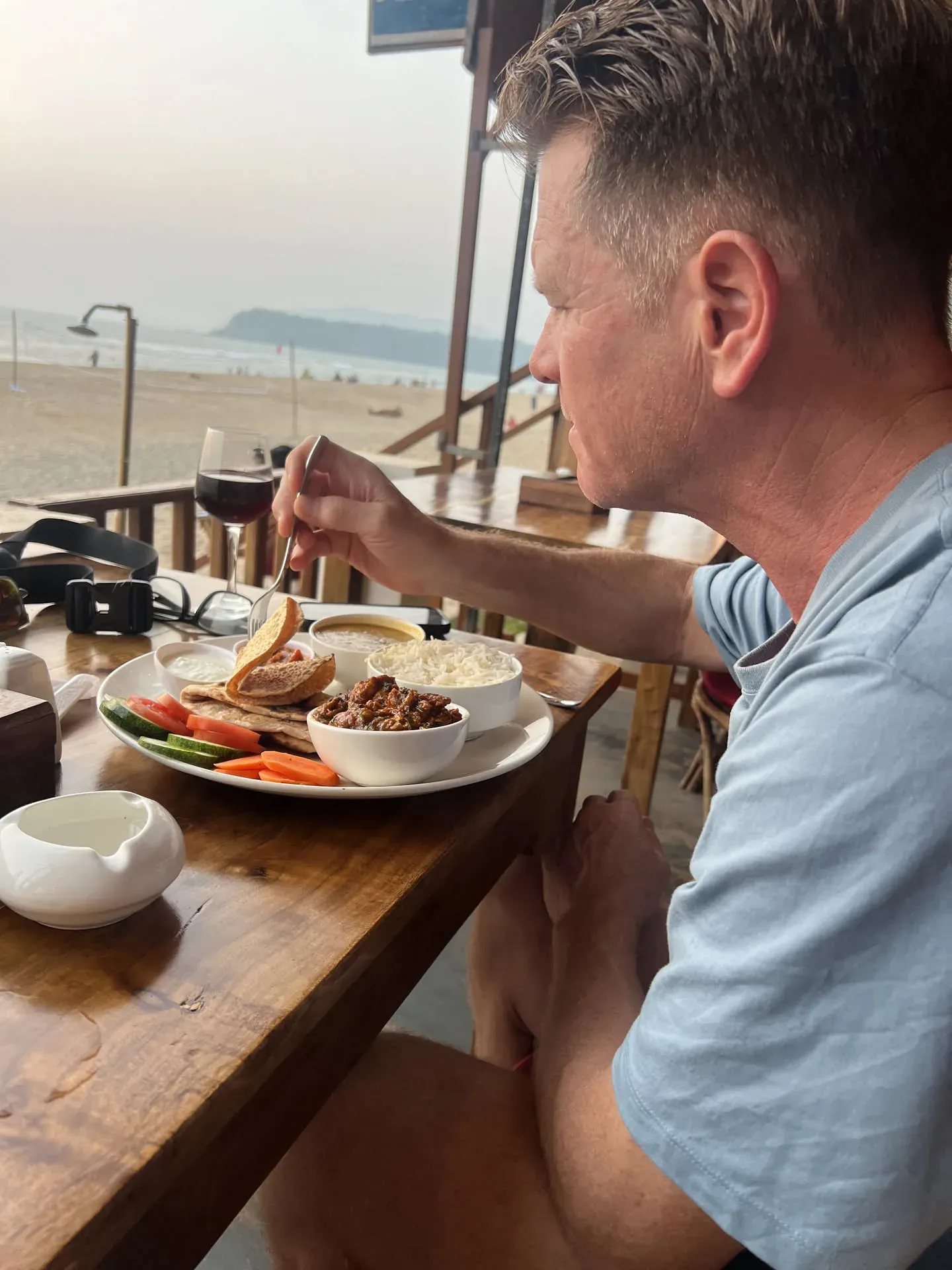 Man enjoying meal with beachside view at Agonda