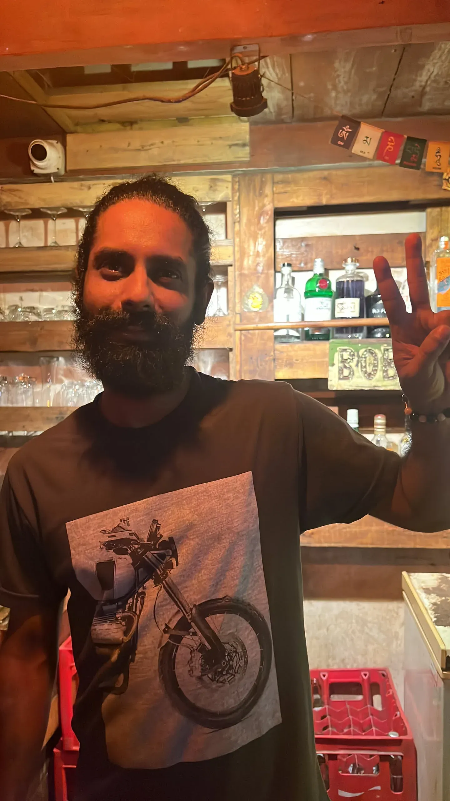 Man with beard in motorcycle shirt at bar