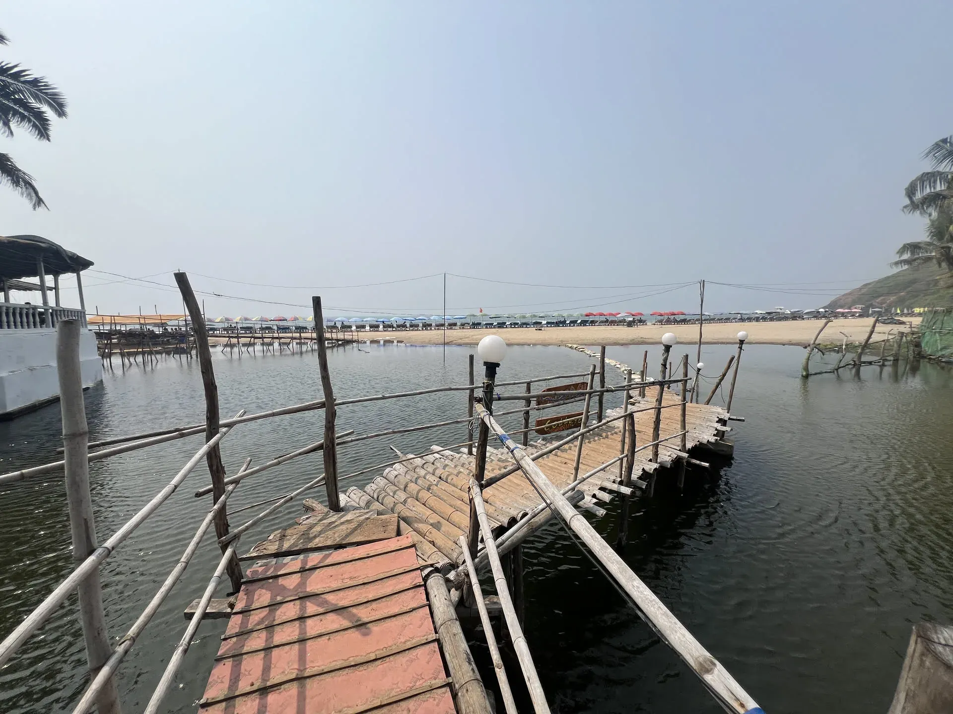 Wooden dock and boats at Querim beach