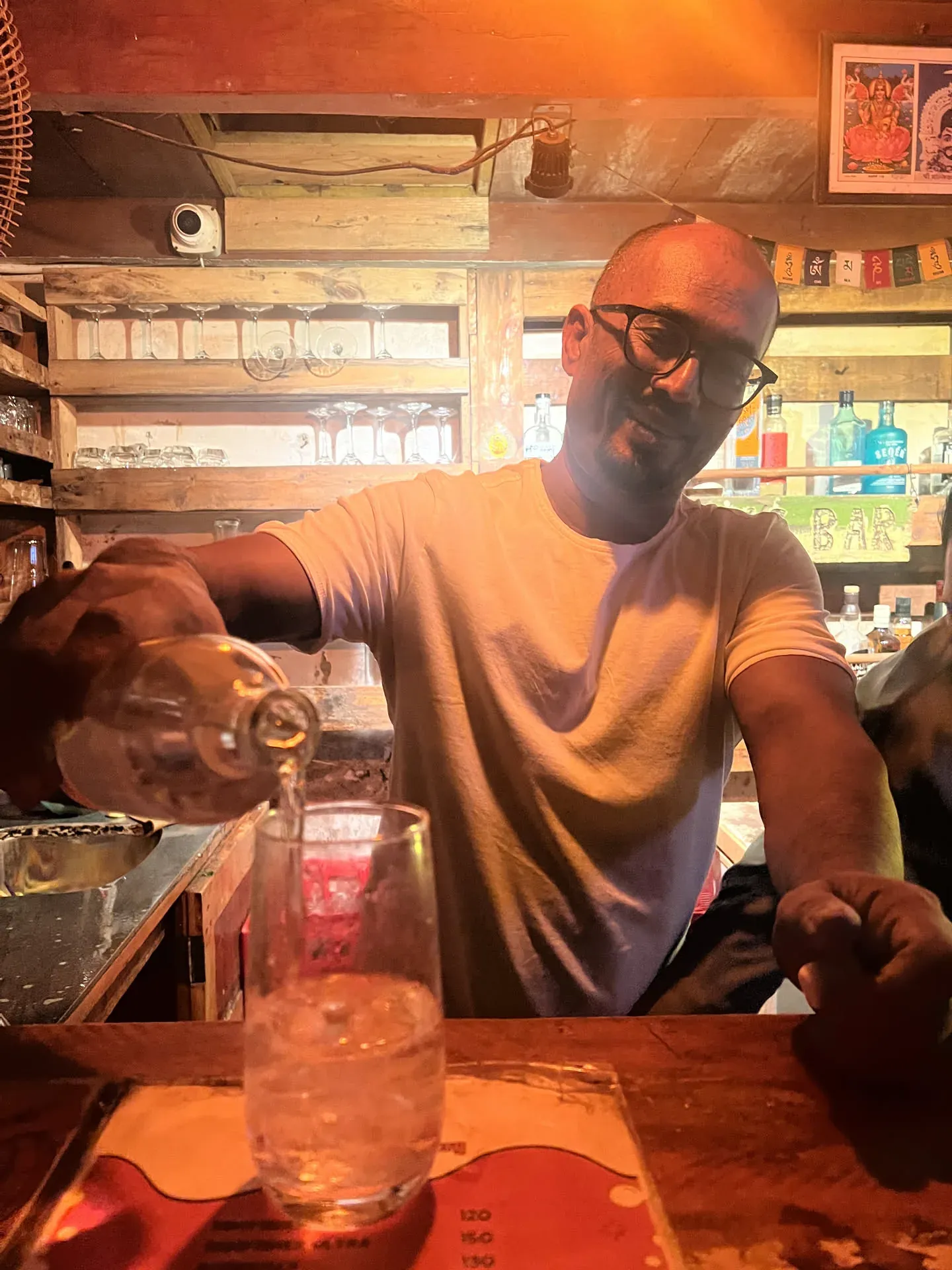 Bartender pouring drink at Agonda beach bar