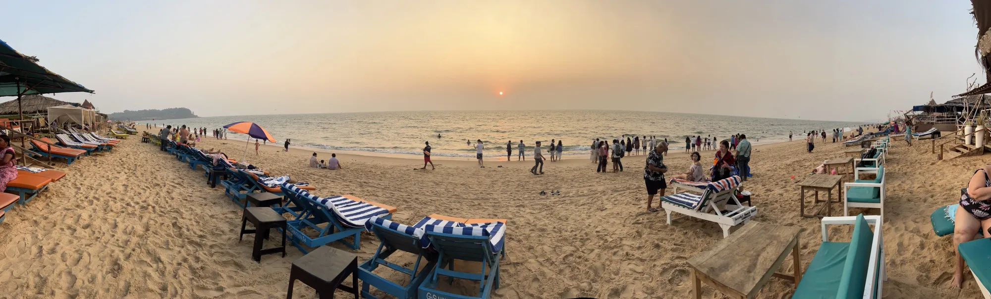 Sunset beach at Marquis Vaddo with loungers and swimmers