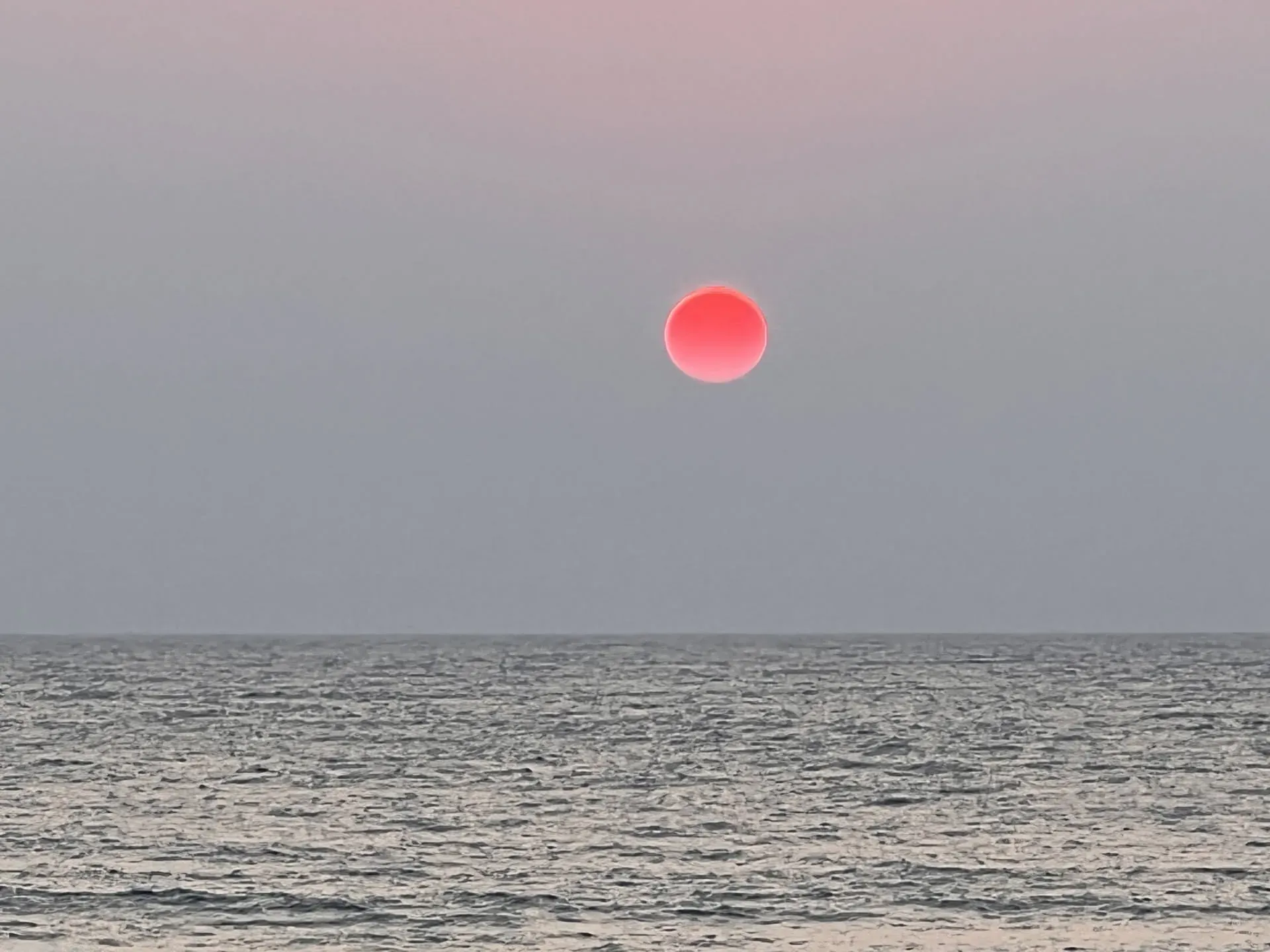 Red sun setting over the ocean at Agonda