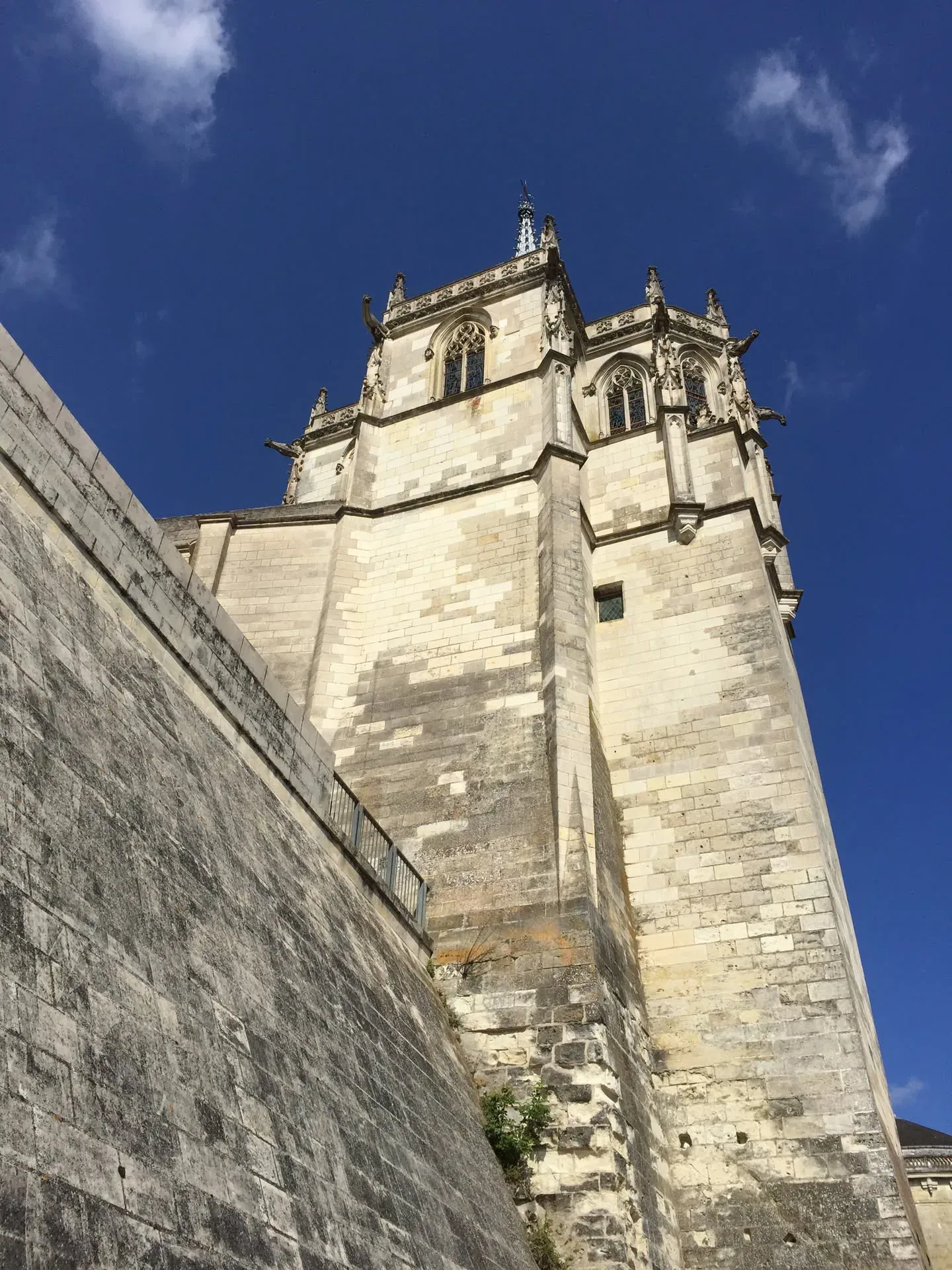 Stone church tower against blue sky, La Ville-Sud