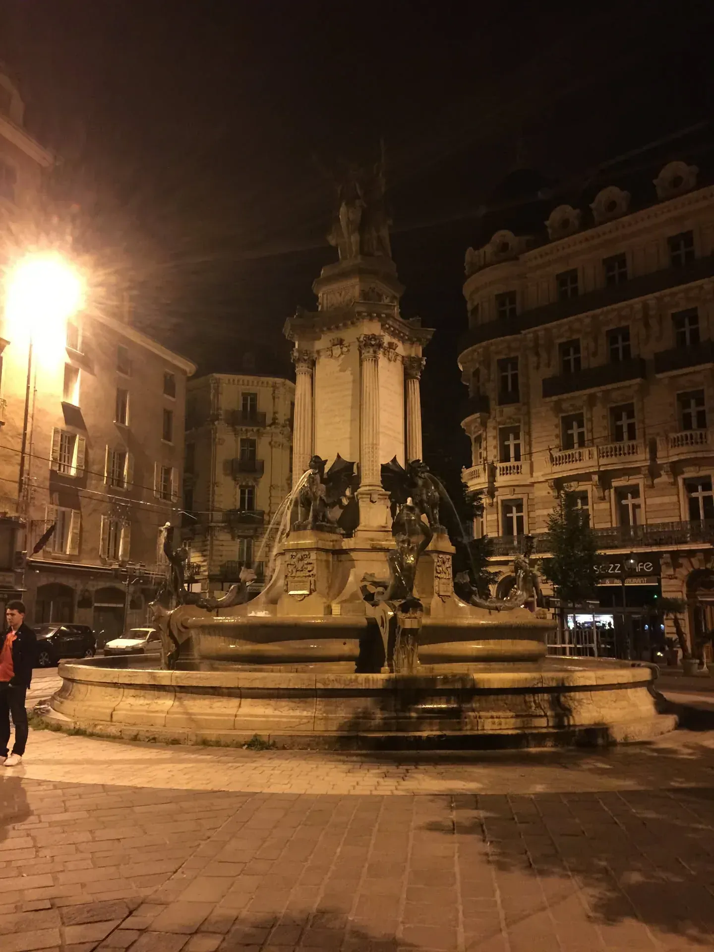 Illuminated monument and church tower at night, Clermont-Ferrand