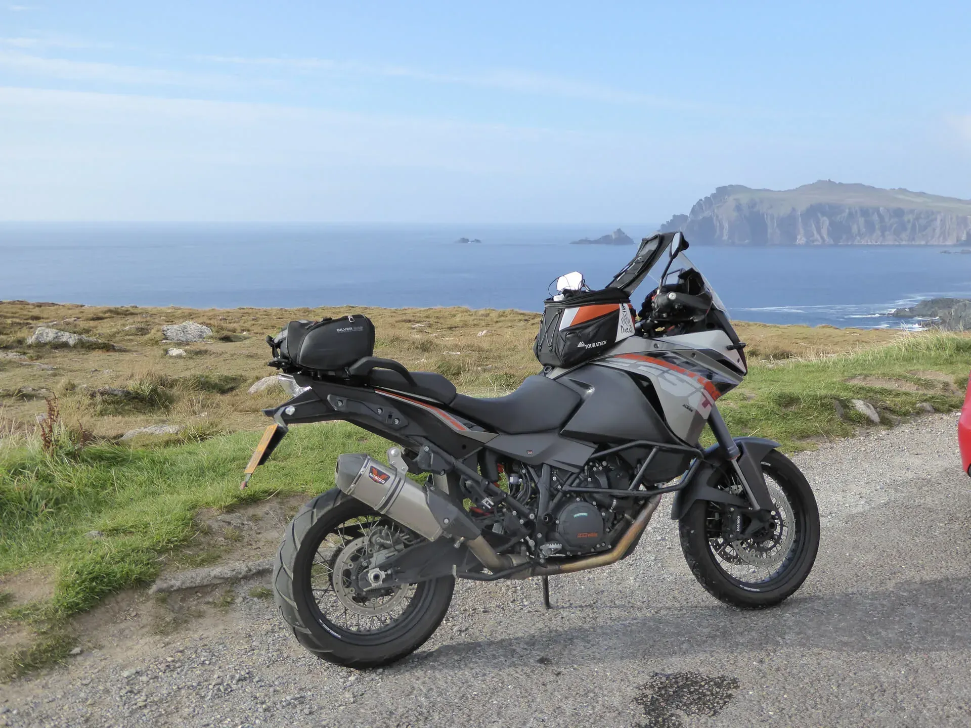 Adventure motorcycle parked at Dunurlin, Ireland coastline